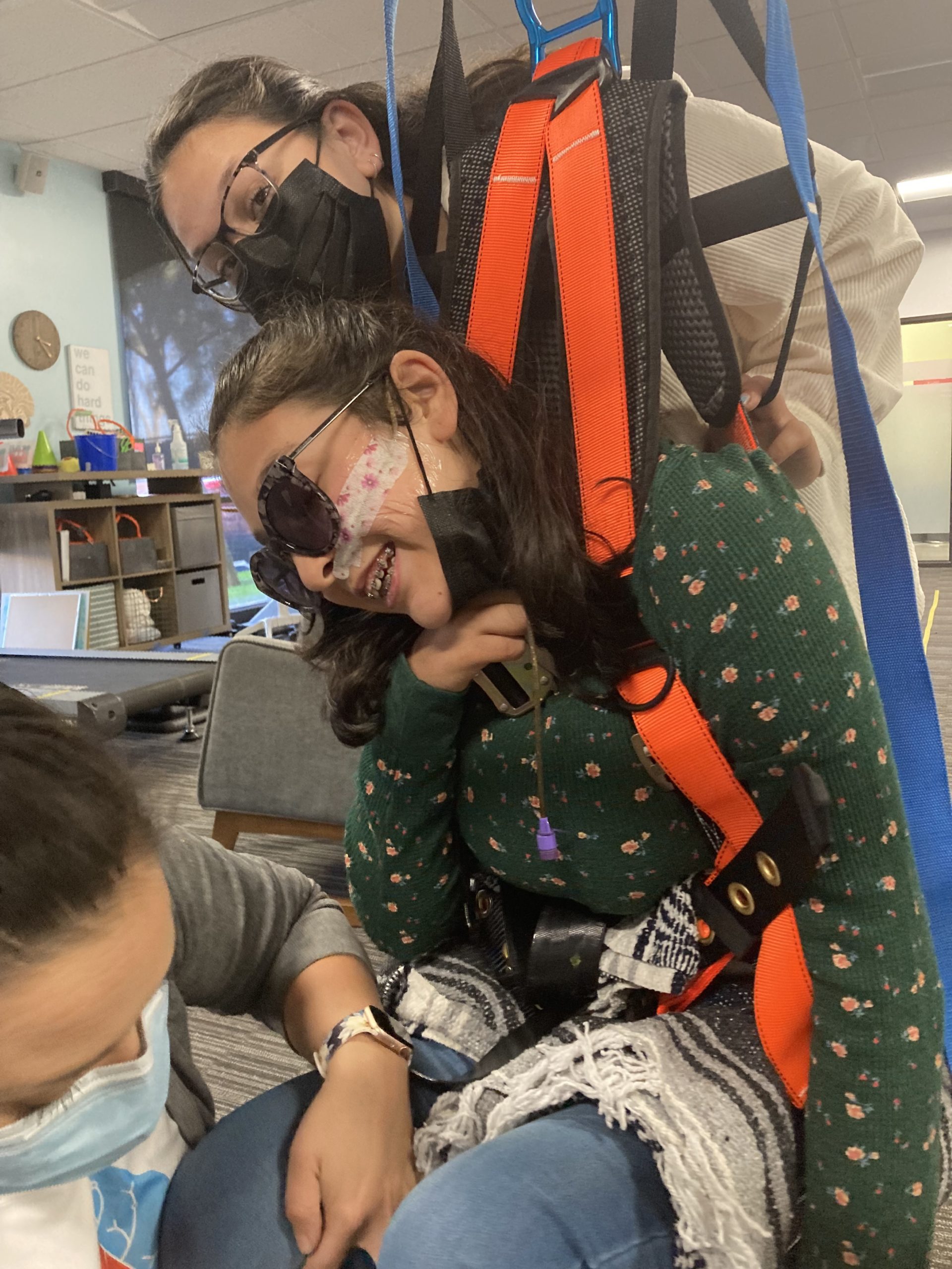 Bella Adlah works with a harness at Re+active Physical Therapy in California.