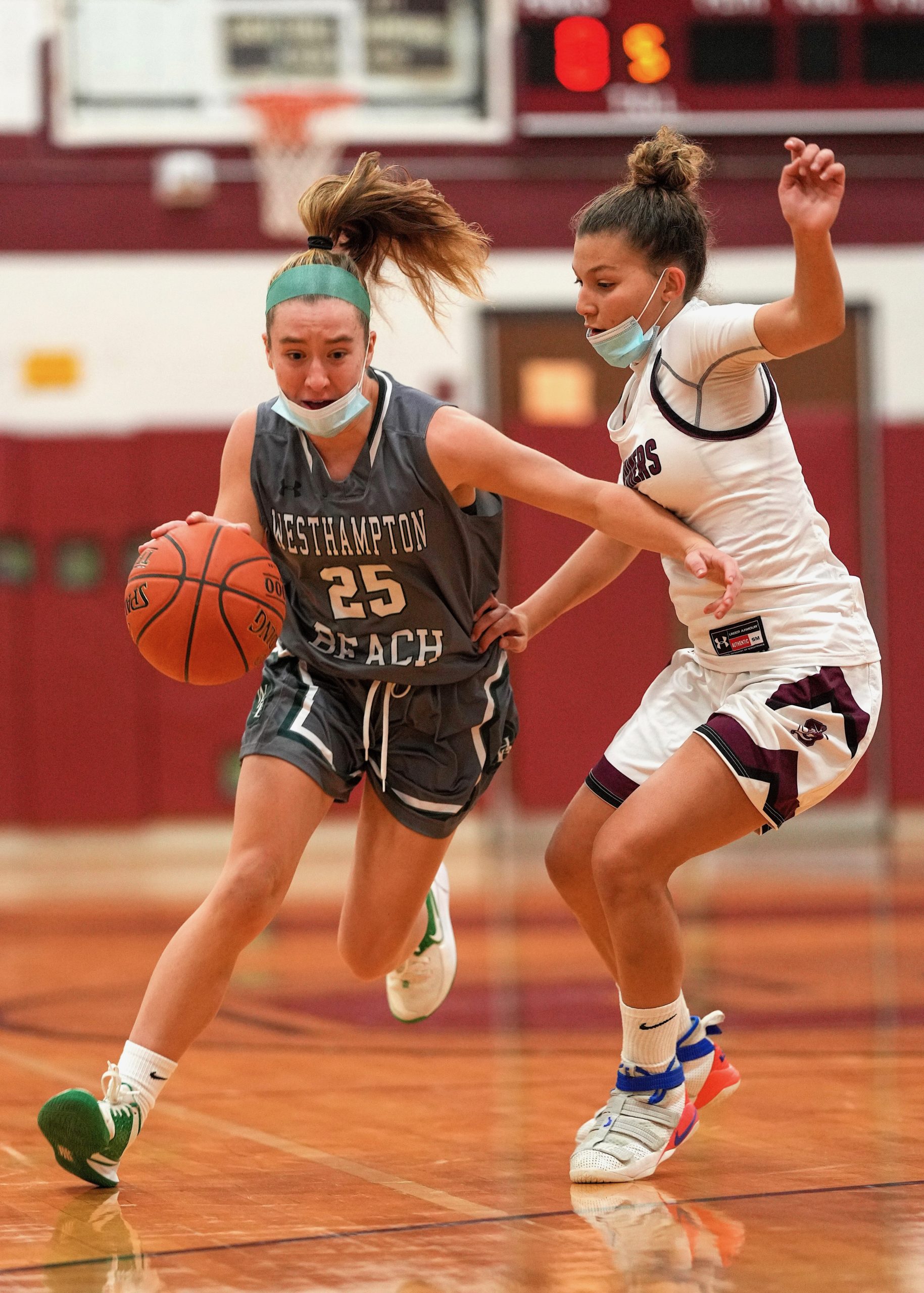 Westhampton Beach senior Lily Berchin moves the ball around Southampton senior Gabby Arnold. RON ESPOSITO