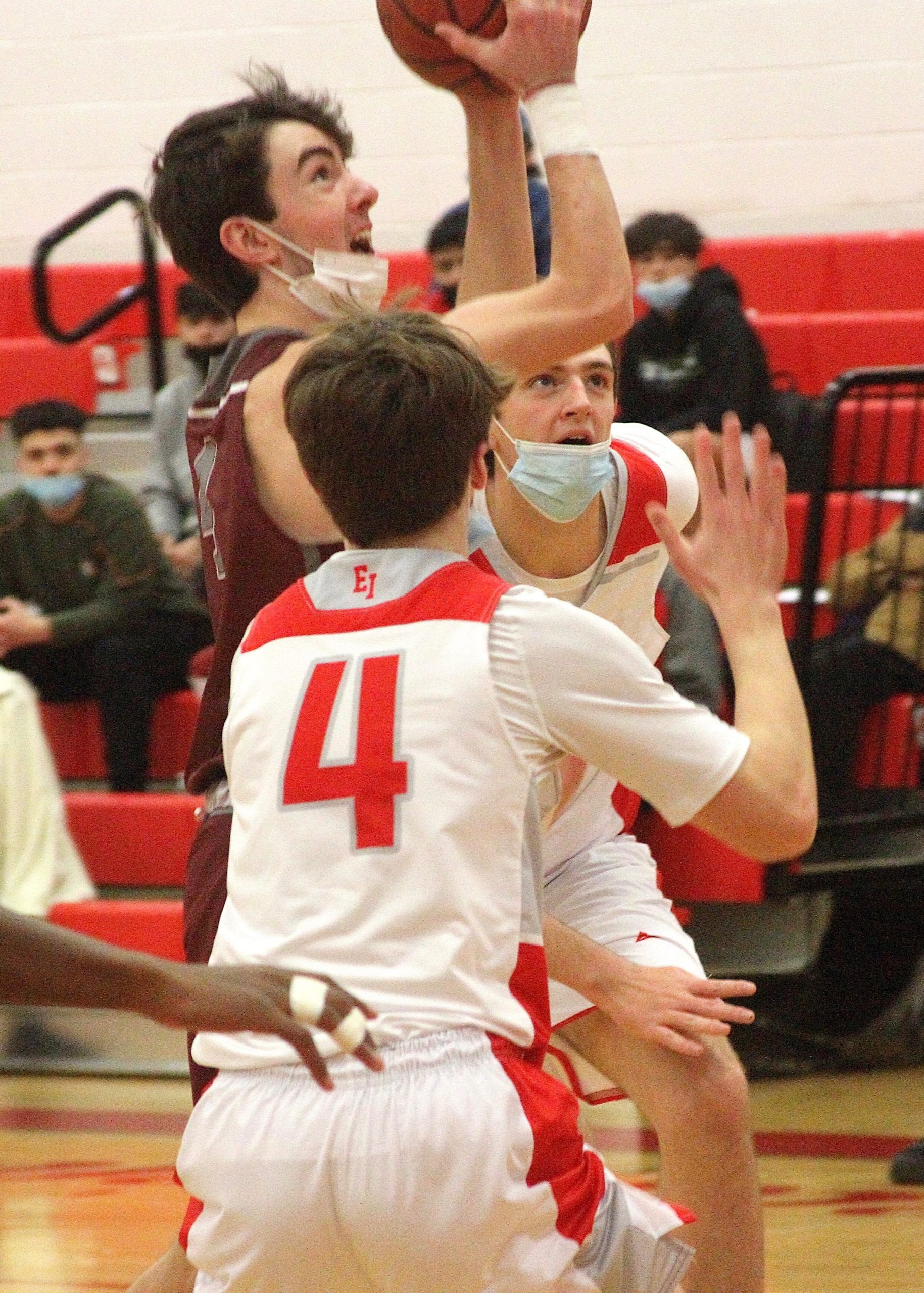 Sophomore guard Liam Fowkes scores a field goal between East Islip's Gavin Veltman (4) and Brandon Kearney. DESIRÉE KEEGAN