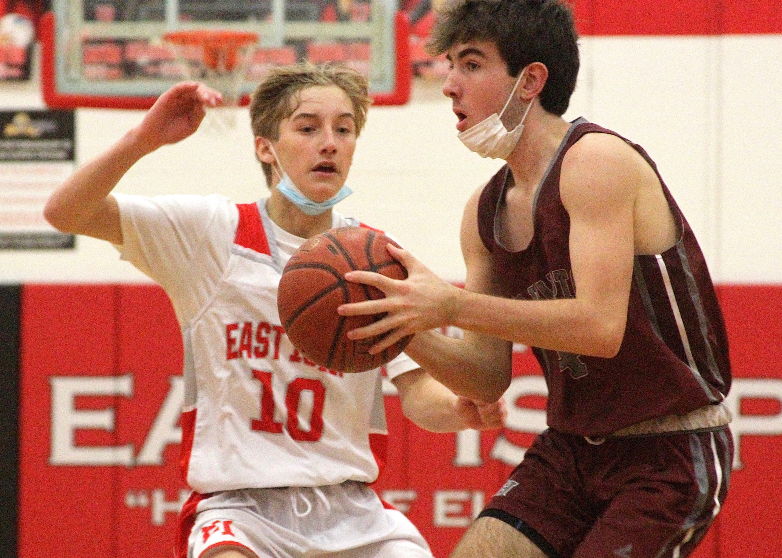 Sophomore guard Liam Fowkes drives the lane around East Islip's John Talt. DESIRÉE KEEGAN