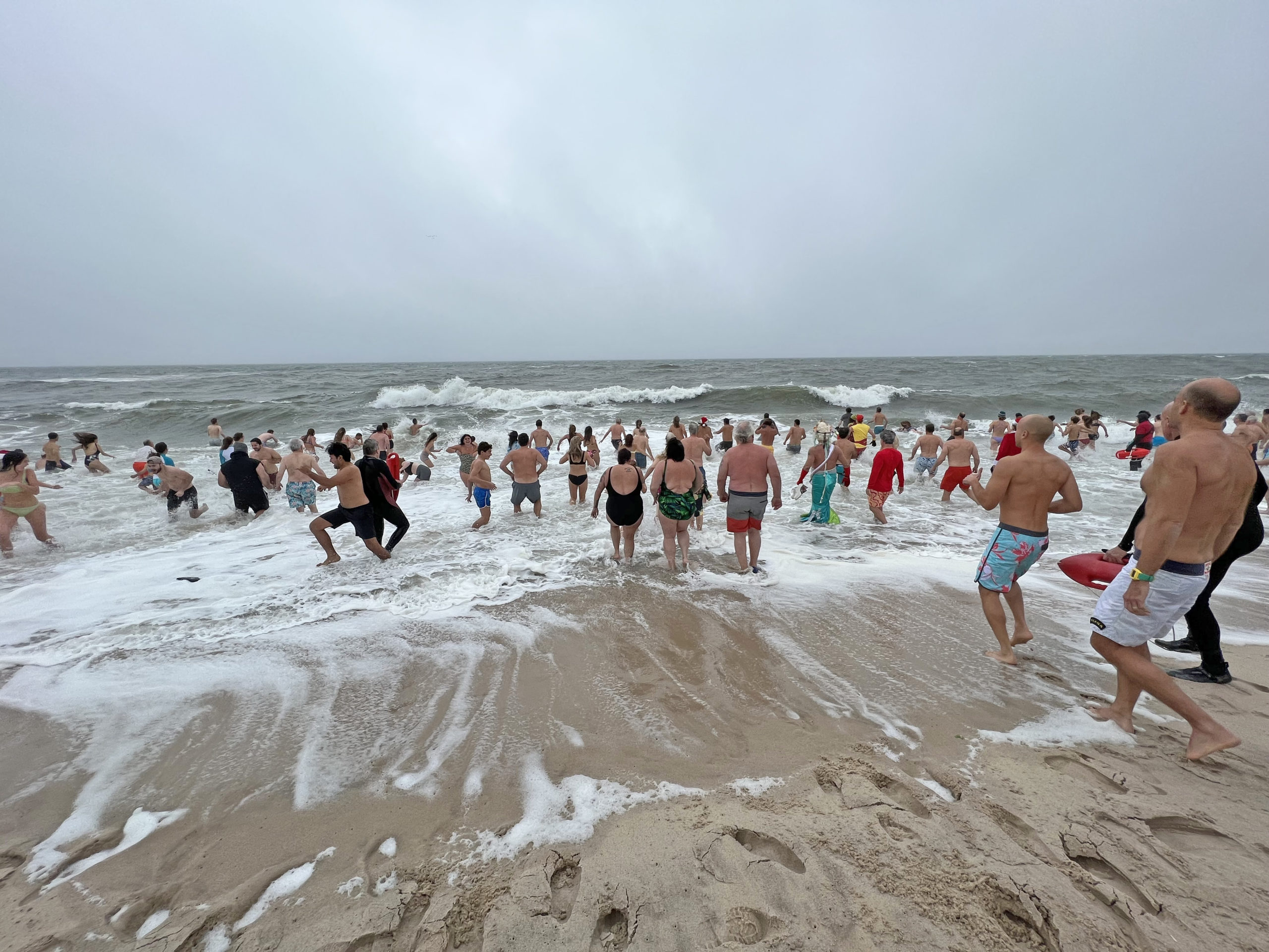 Participants of the 2021 Polar Bear Plunge brave rough conditions on Saturday morning.  DANA SHAW