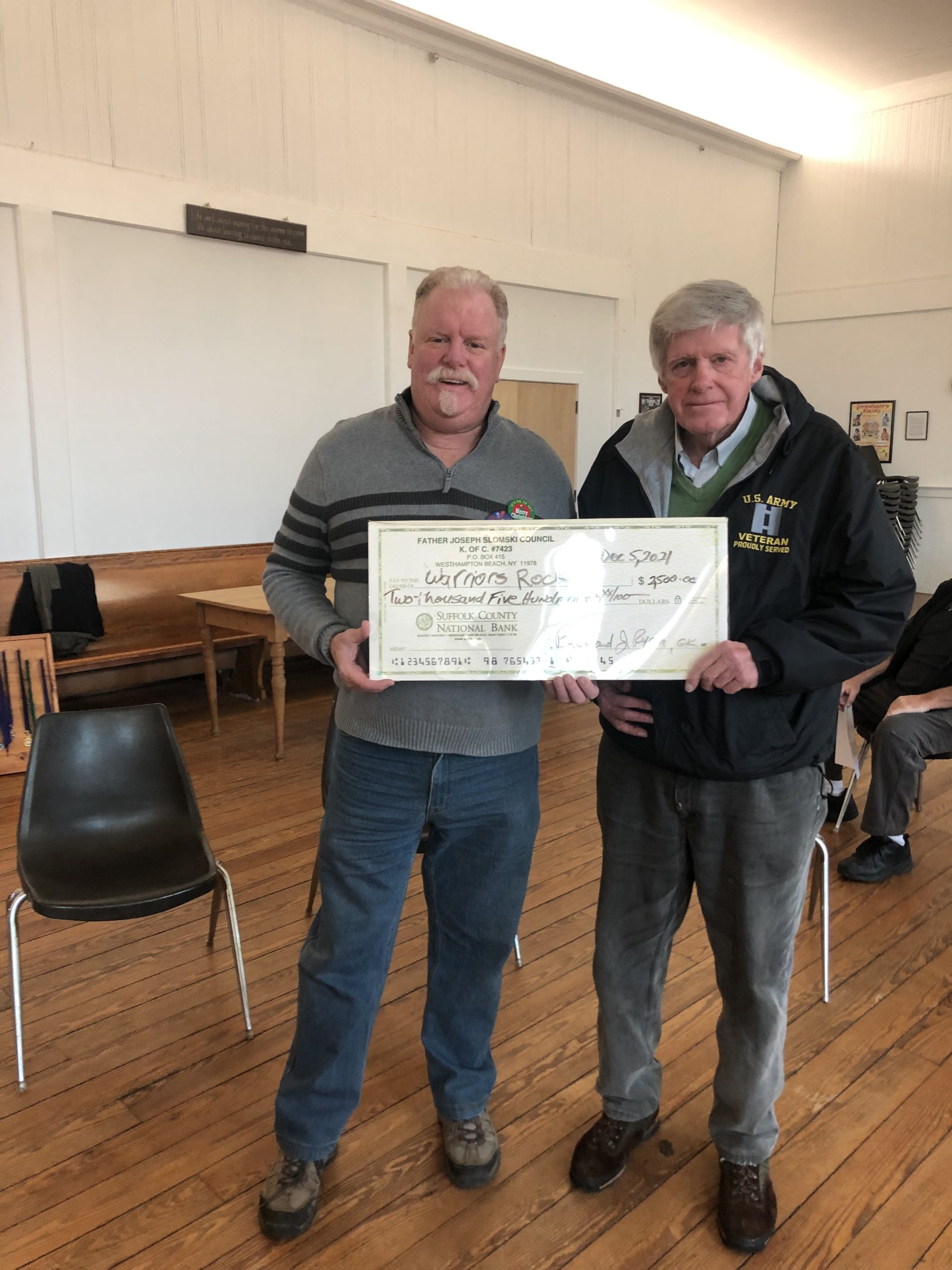 Knights of Columbus Grand Knight Barney Ryan presents $2500 check to George Motz for the Warriors Rock concert, which helps raise money for local veterans groups.
