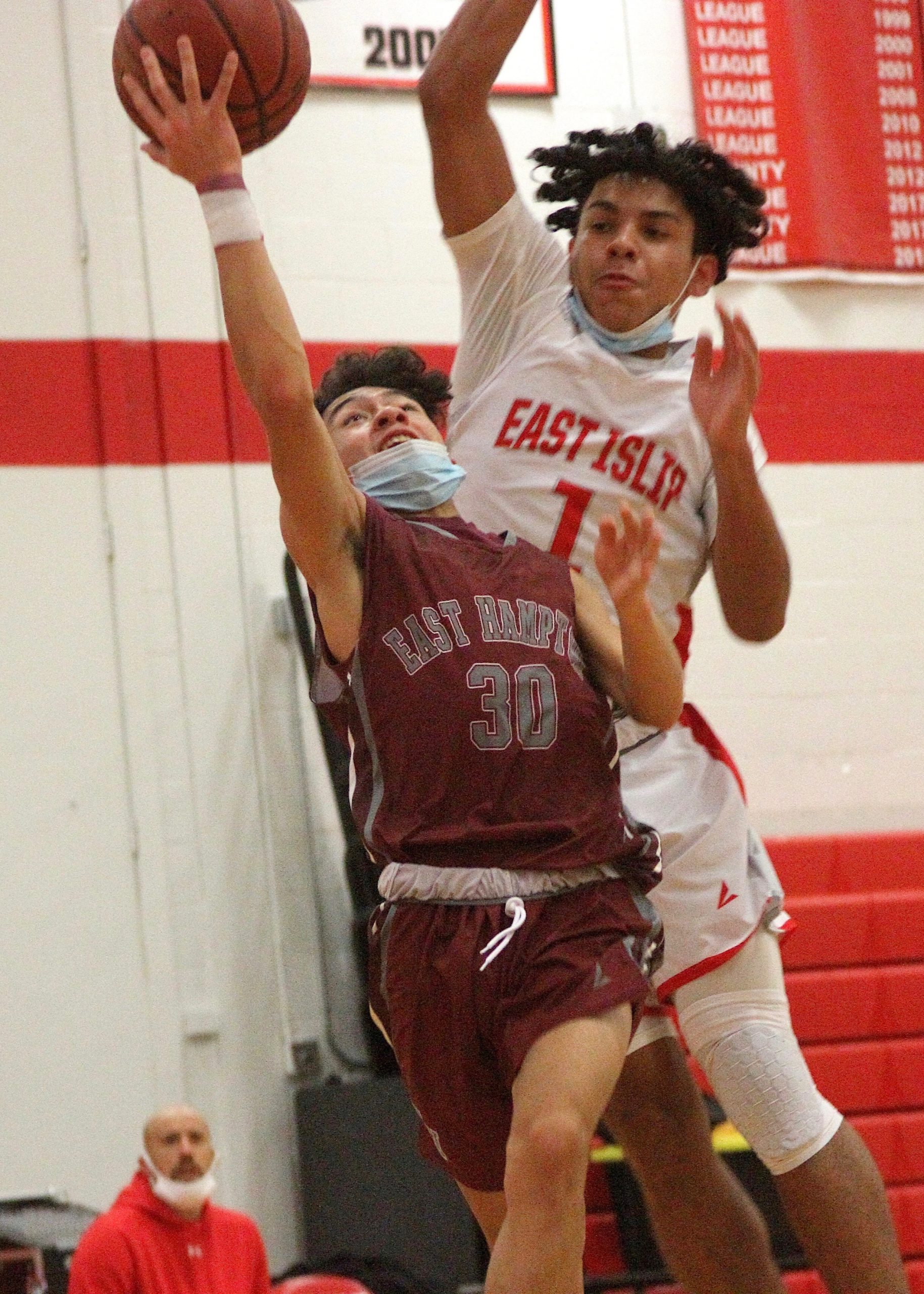 Senior guard Hector Montanaldo jumps for the layup ahead of East Islip's Kenny Rodriguez. DESIRÉE KEEGAN