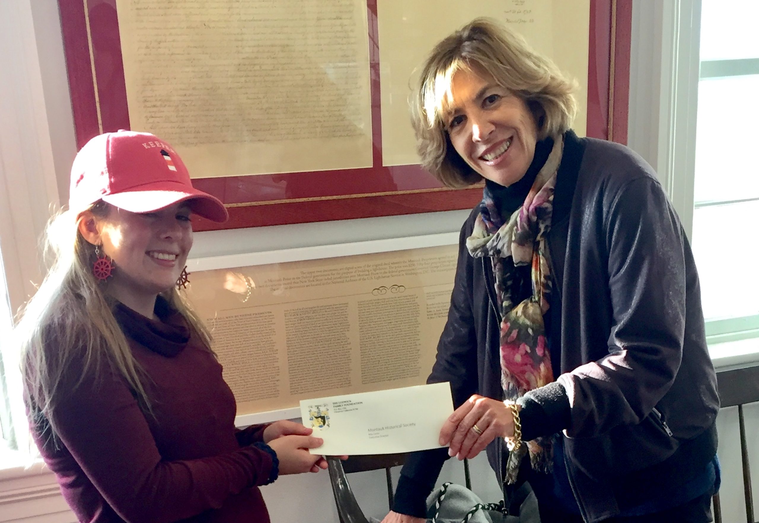 Nicole Warner presents a check to Mia Certic.