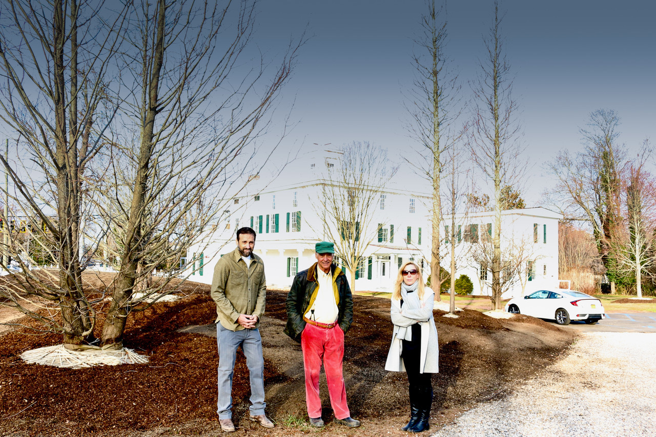 Silas and Charlie Marder (center) with Nina Dec, director of the Bridgehampton Museum, among a newly planted stand of trees at the entryway to the Rogers House in Bridgehampton.    Peter Boody photo