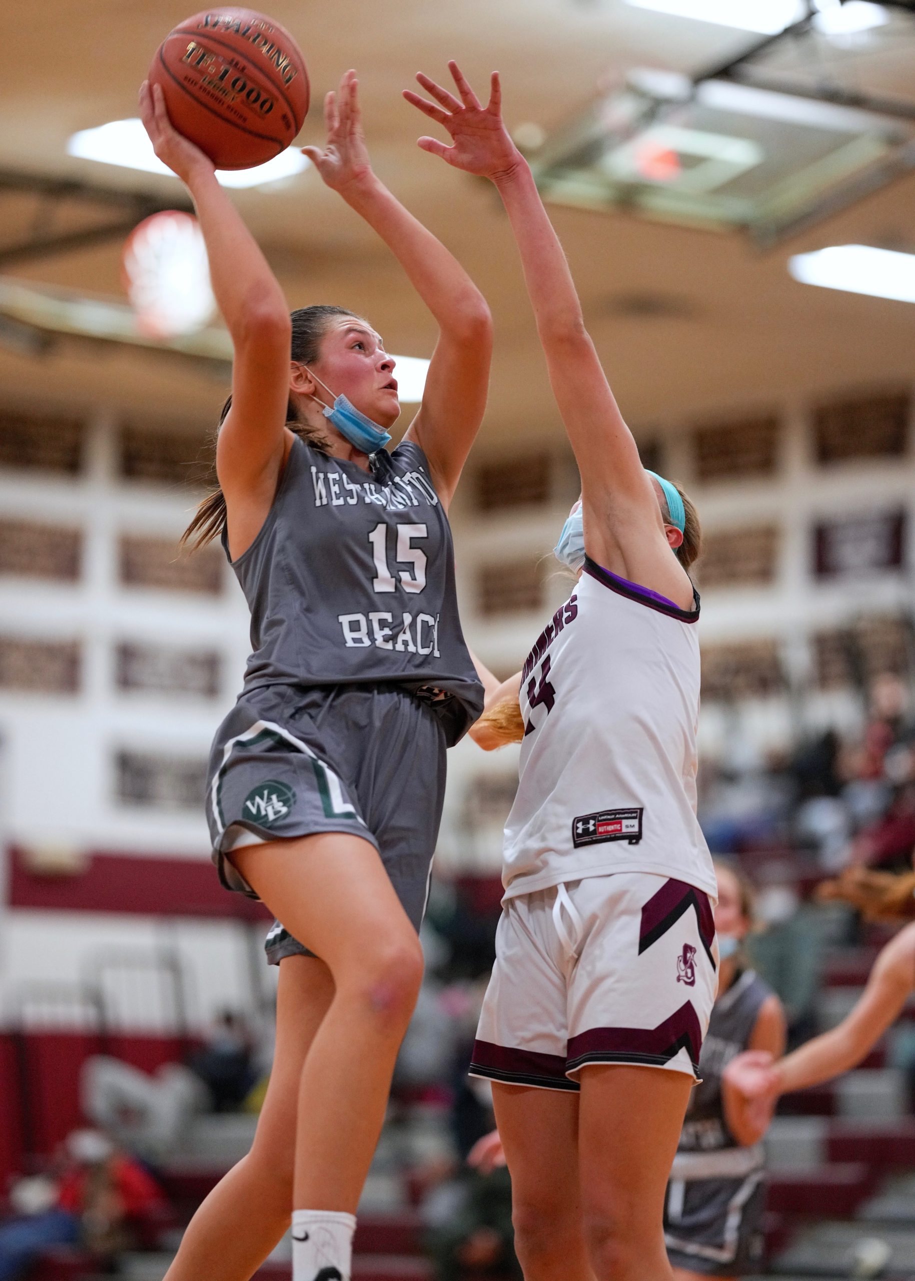 Westhampton Beach senior Olivia Rongo reaches for the basket. RON ESPOSITO