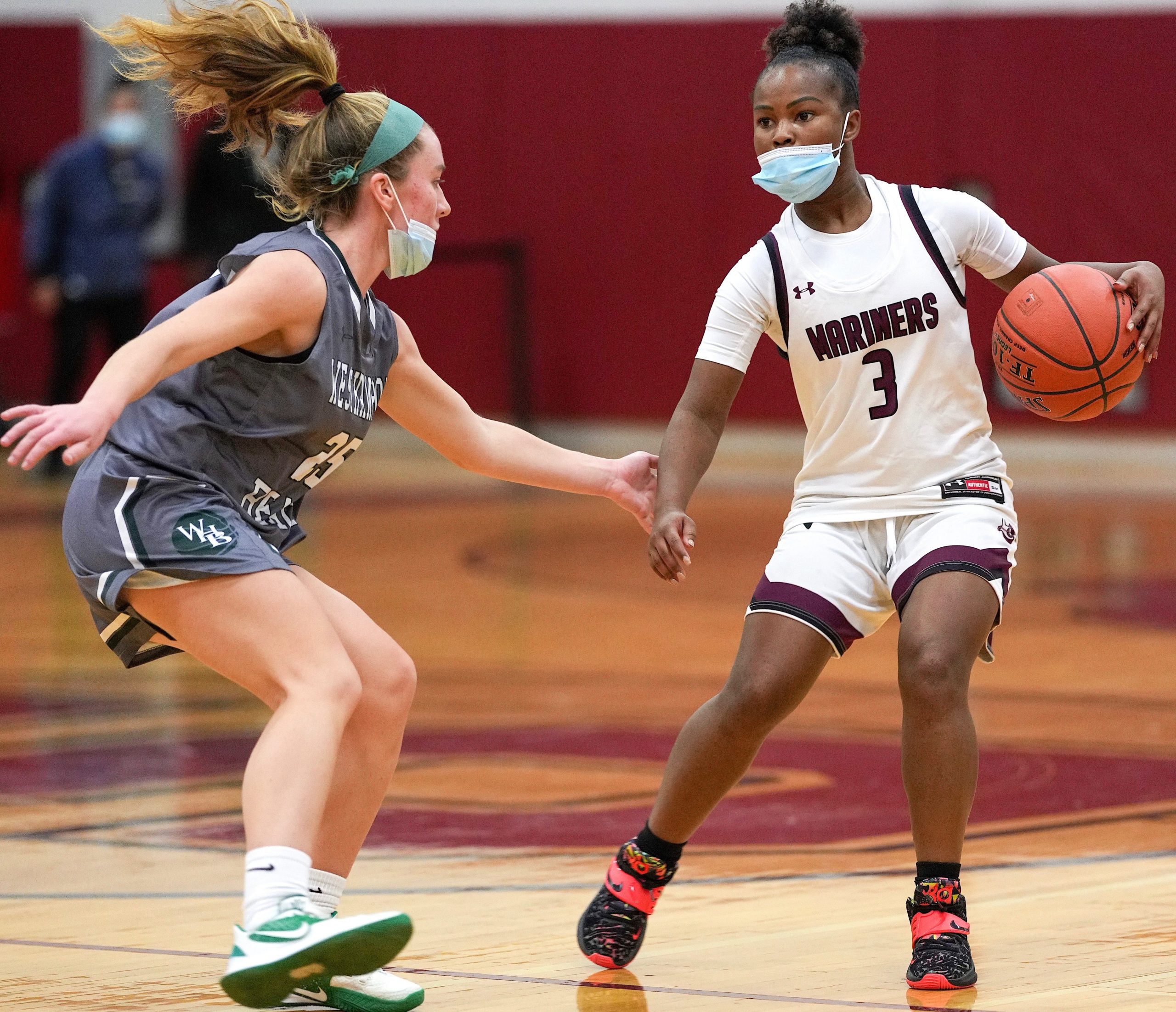 Southampton senior Madison Taylor looks to may a play behind Westhampton Beach senior Lily Berchin. RON ESPOSITO