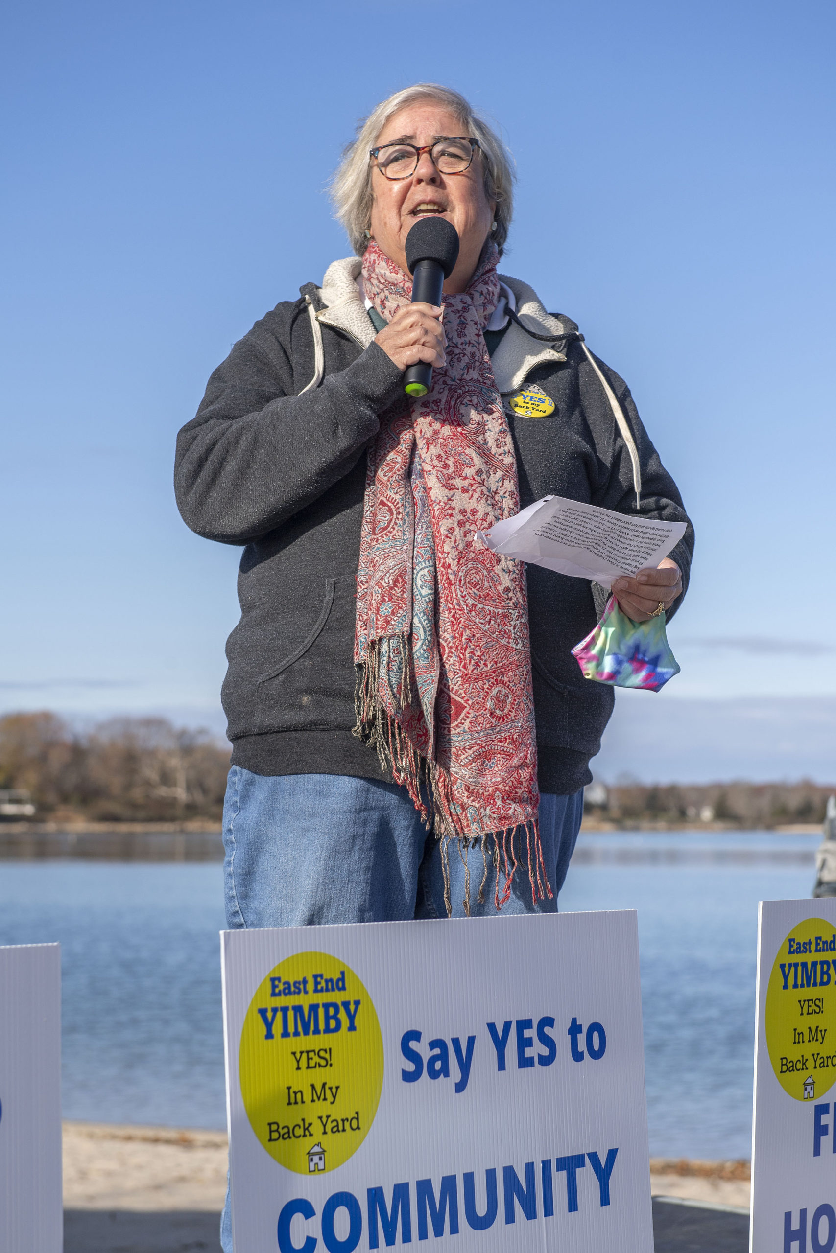 Sag Harbor Chamber of Commerce President Ellen Dioguardi speaks at the East End YIMBY Rally for Affordable Housing, at the windmill on Long Wharf in Sag Harbor on Saturday.   MICHAEL HELLER