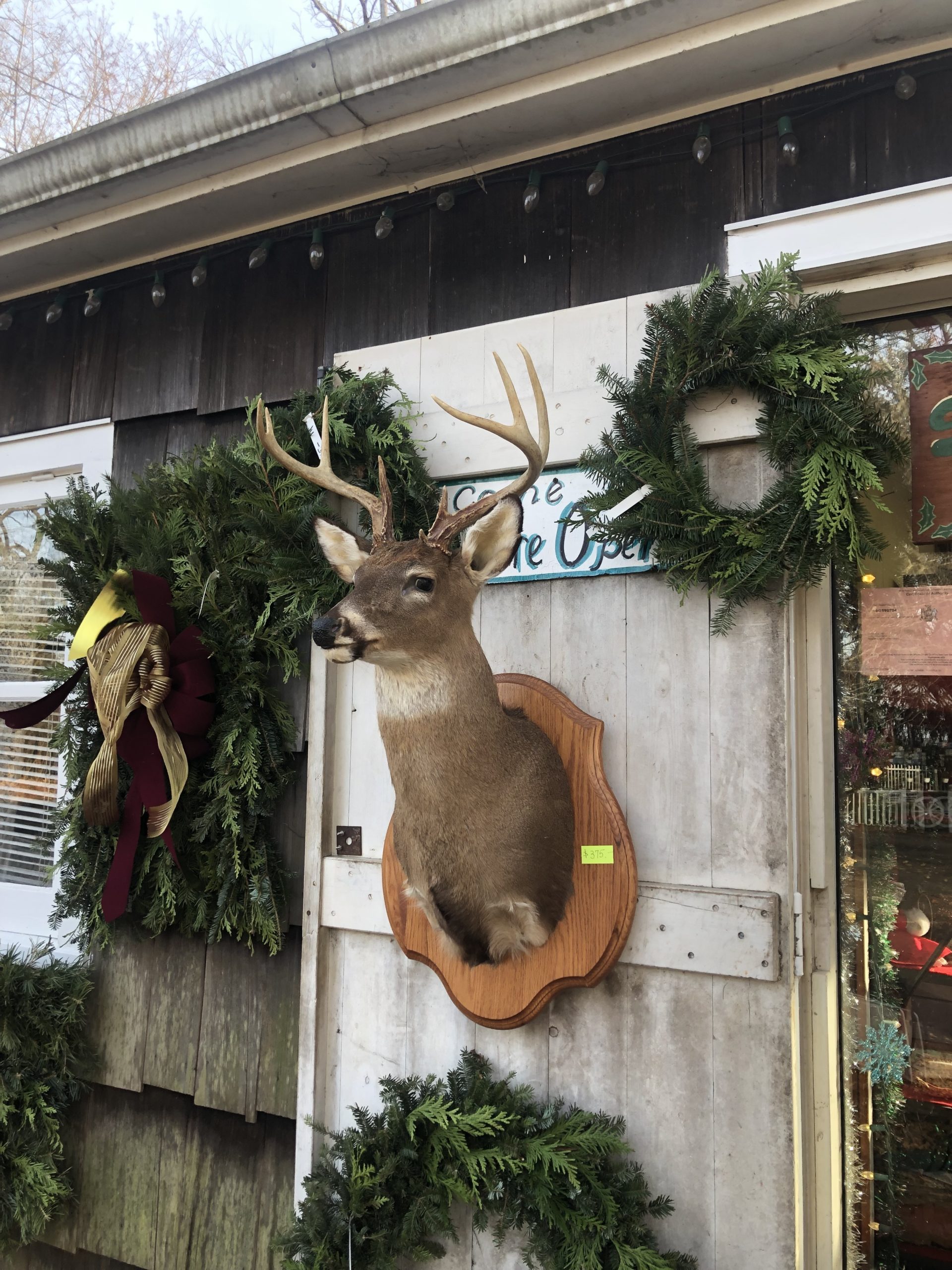 Walter Olsen makes homemade wreaths in his workshop, in between helping customers pick out a tree.