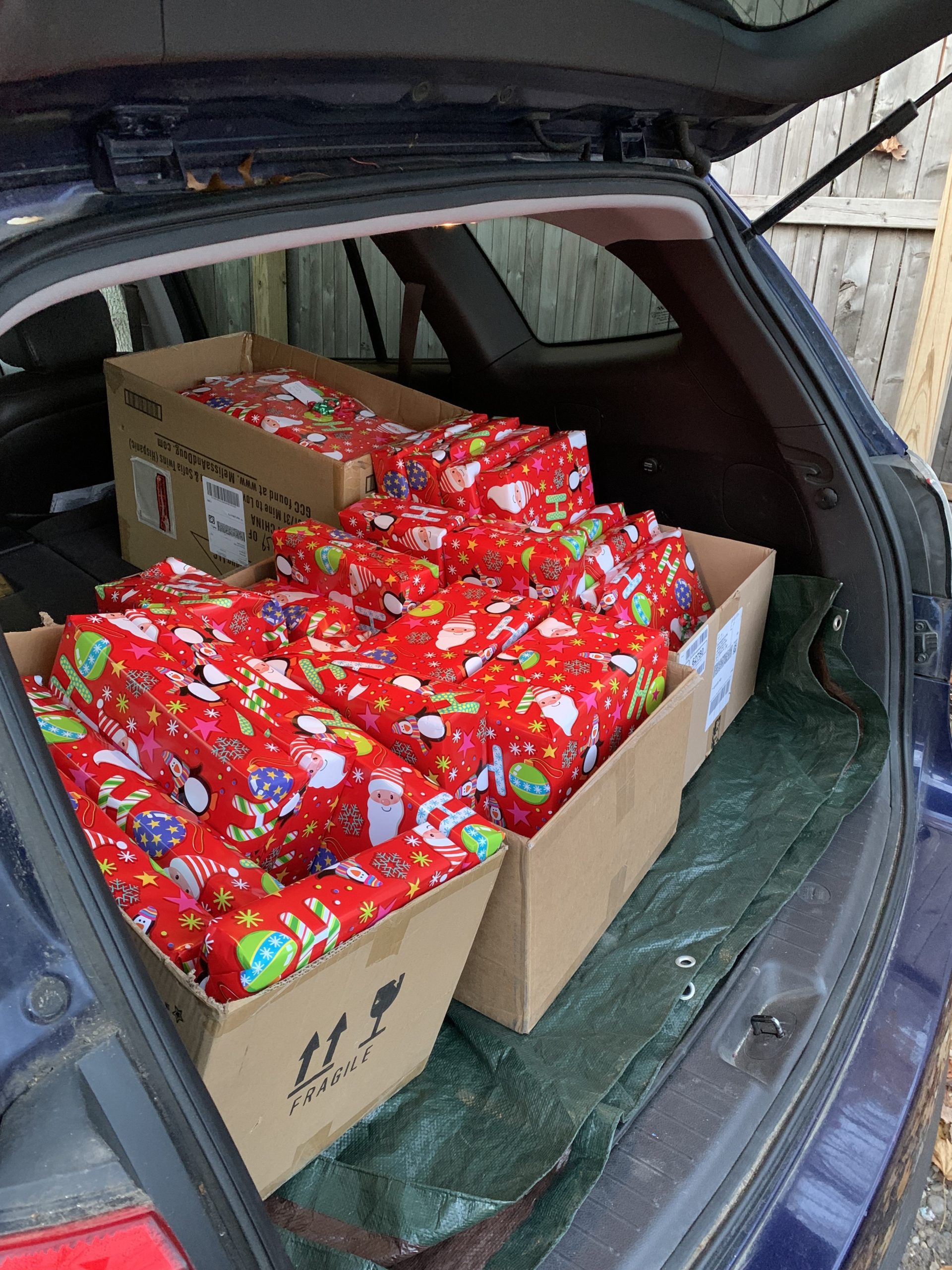 Wrapped gifts for students in the Bridgehampton Head Start preschool program loaded into Wharf Shop owner Gwen Waddington's car, ready for delivery.
