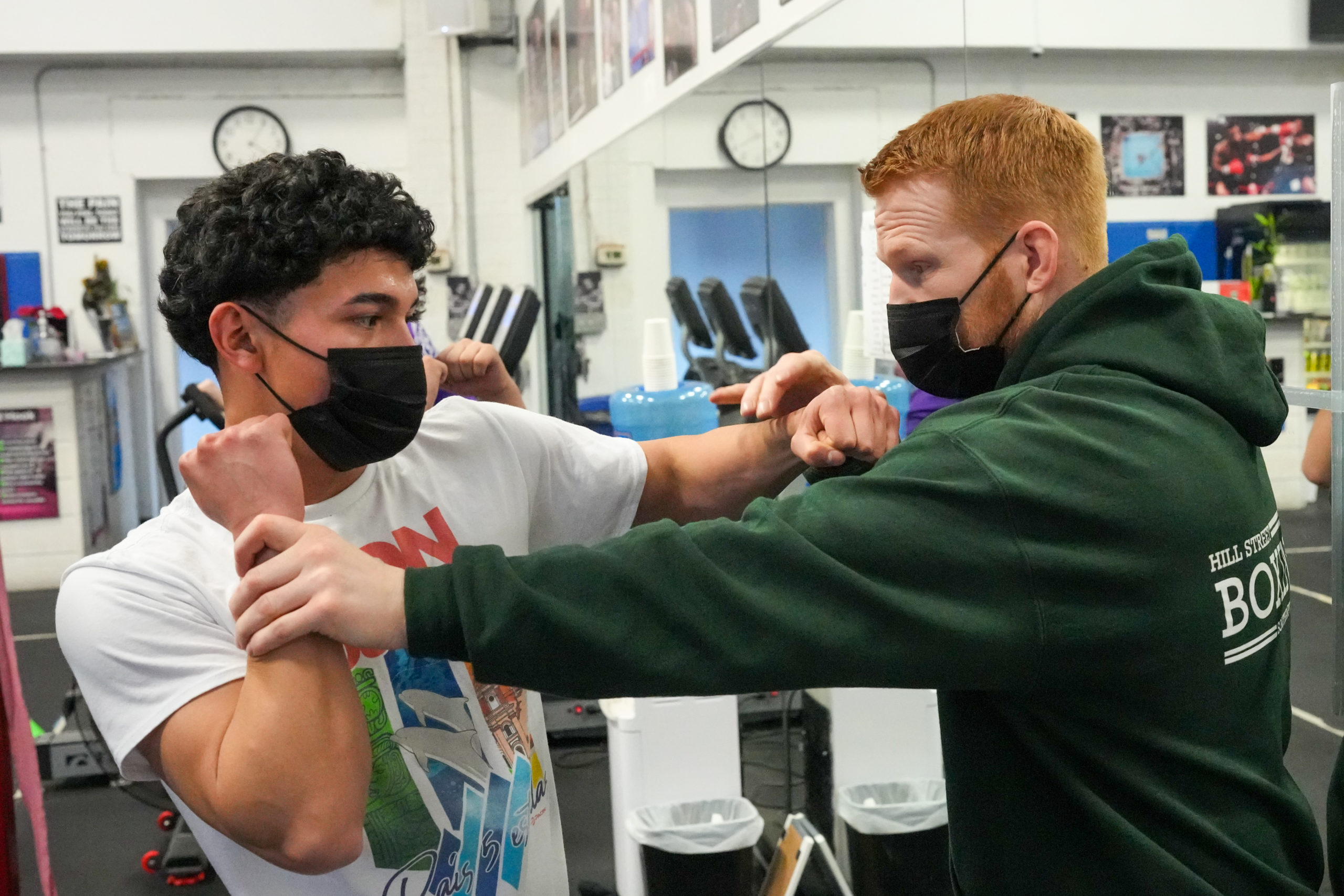 Hill Street Boxing manager and trainer Avery Crocker works with Hampton Bays student Erick Acosta. RON ESPOSITO