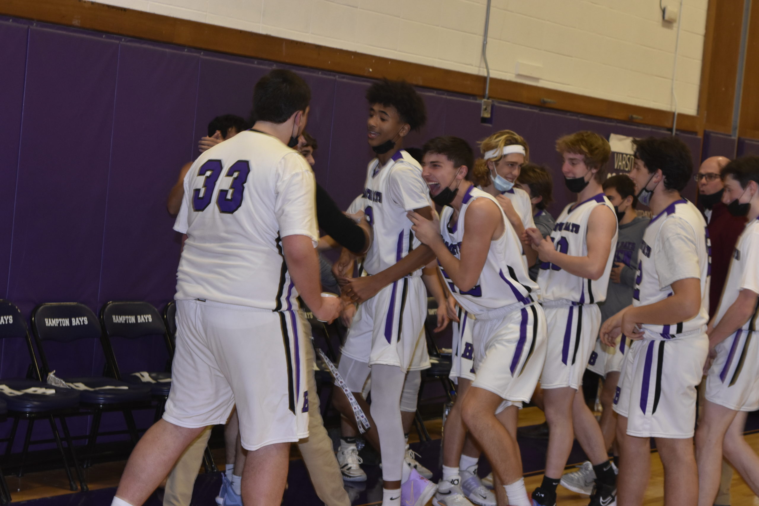 Hampton Bays junior Kazmin Pensa-Johnson is congratulated by his teammates after his big play to end the first quarter.