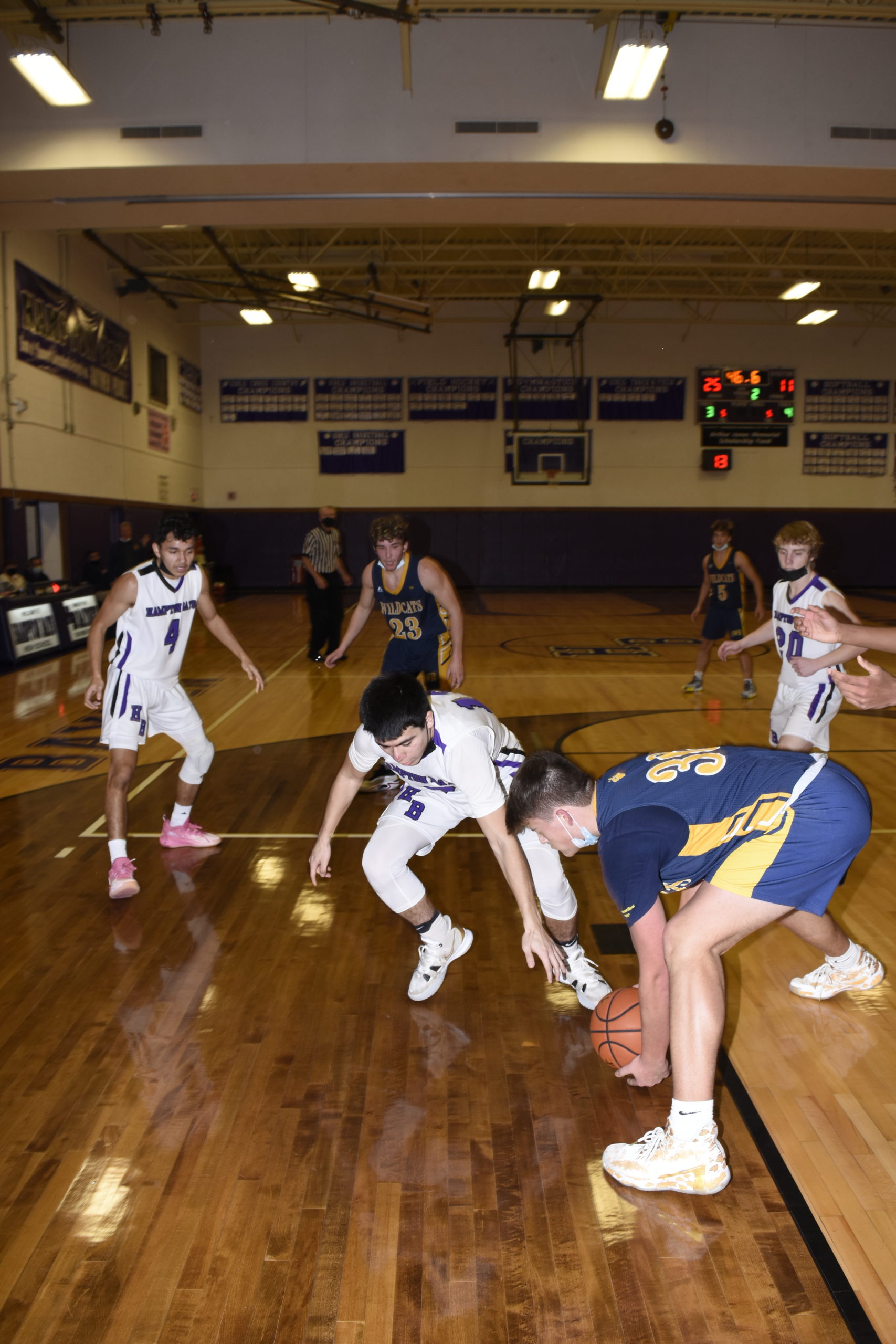 Hampton Bays senior Chris Sanchez and a Shoreham-Wading River player go after a loose ball.