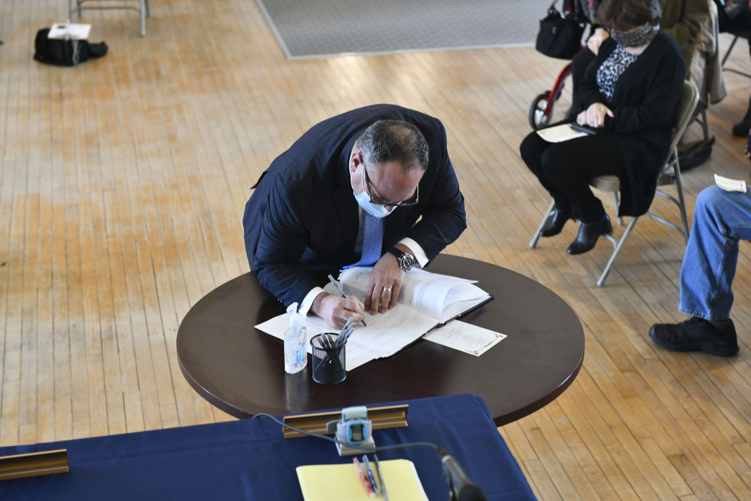 Southampton Town Trustee Scott Horowitz signs the book after being sworn in.