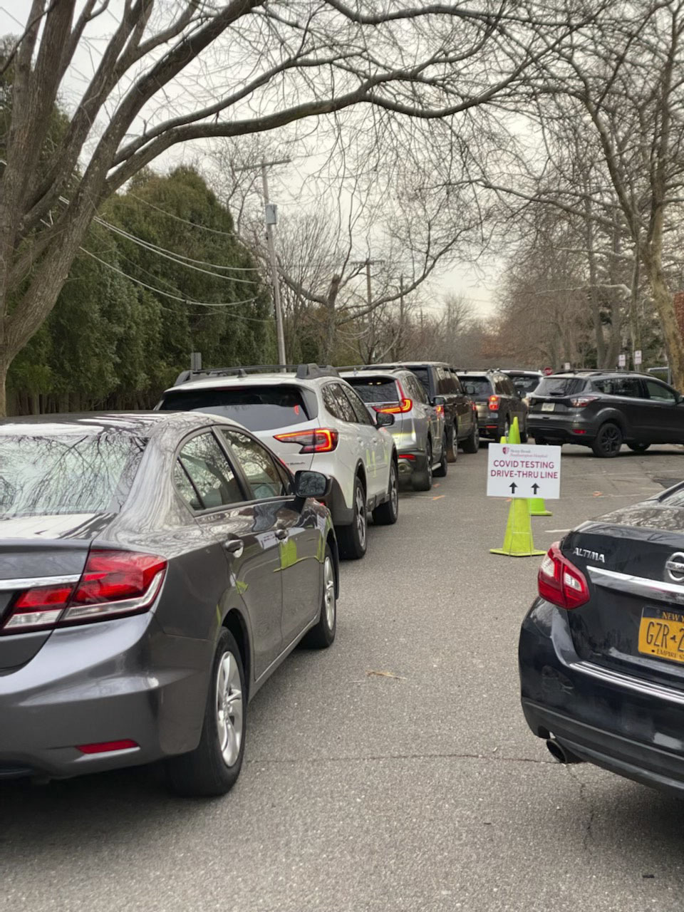 The line for drive-thru Coronavirus testing at Stony Brook Southampton Hospital has stretched farther and father down Herrick Road as the omicron variant fuels a spike in cases.   MICHAEL WRIGHT