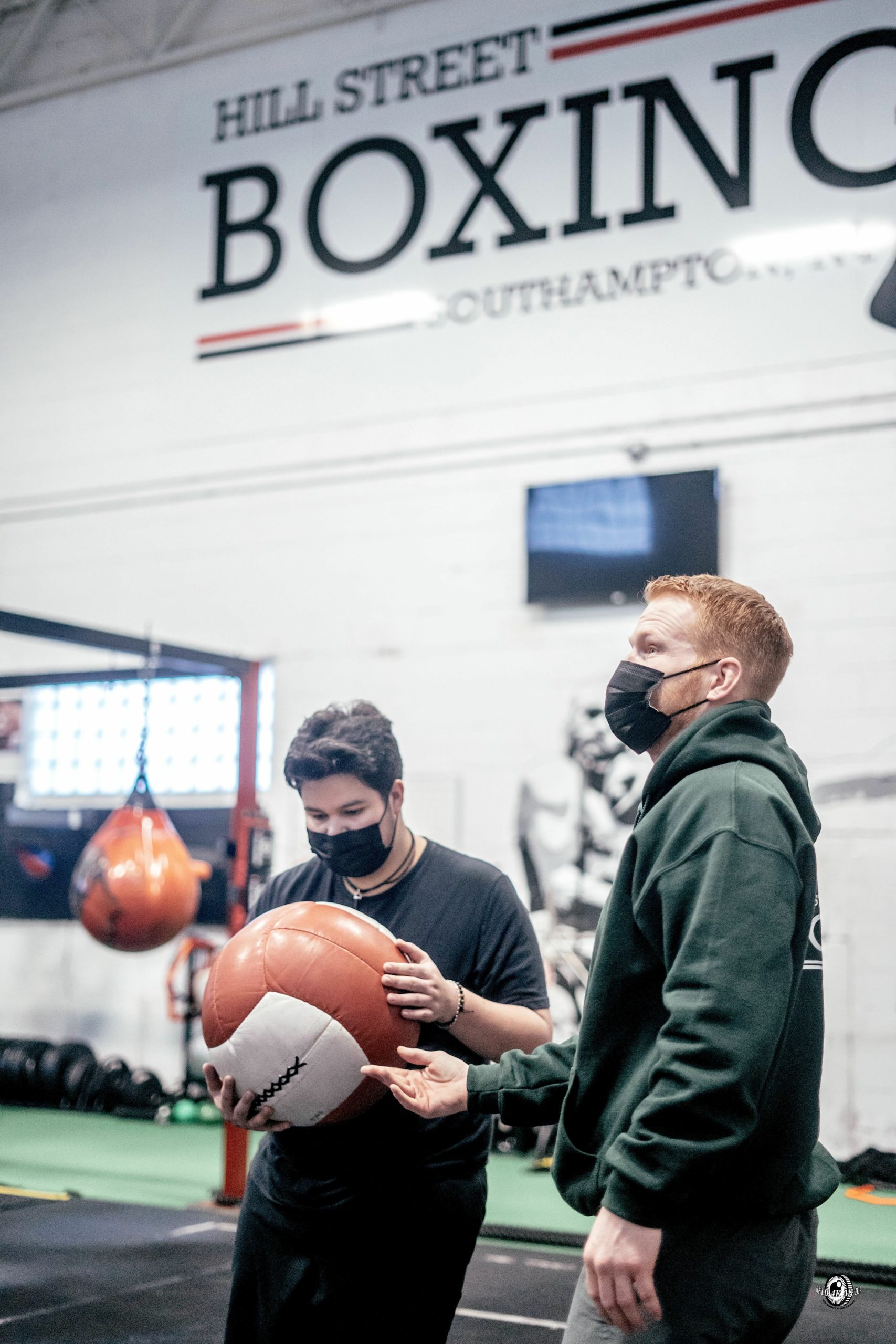 Hampton Bays student Juan Fernández and Hill Street Boxing manager and trainer Avery Crocker during a drill. DYLAN FLORES