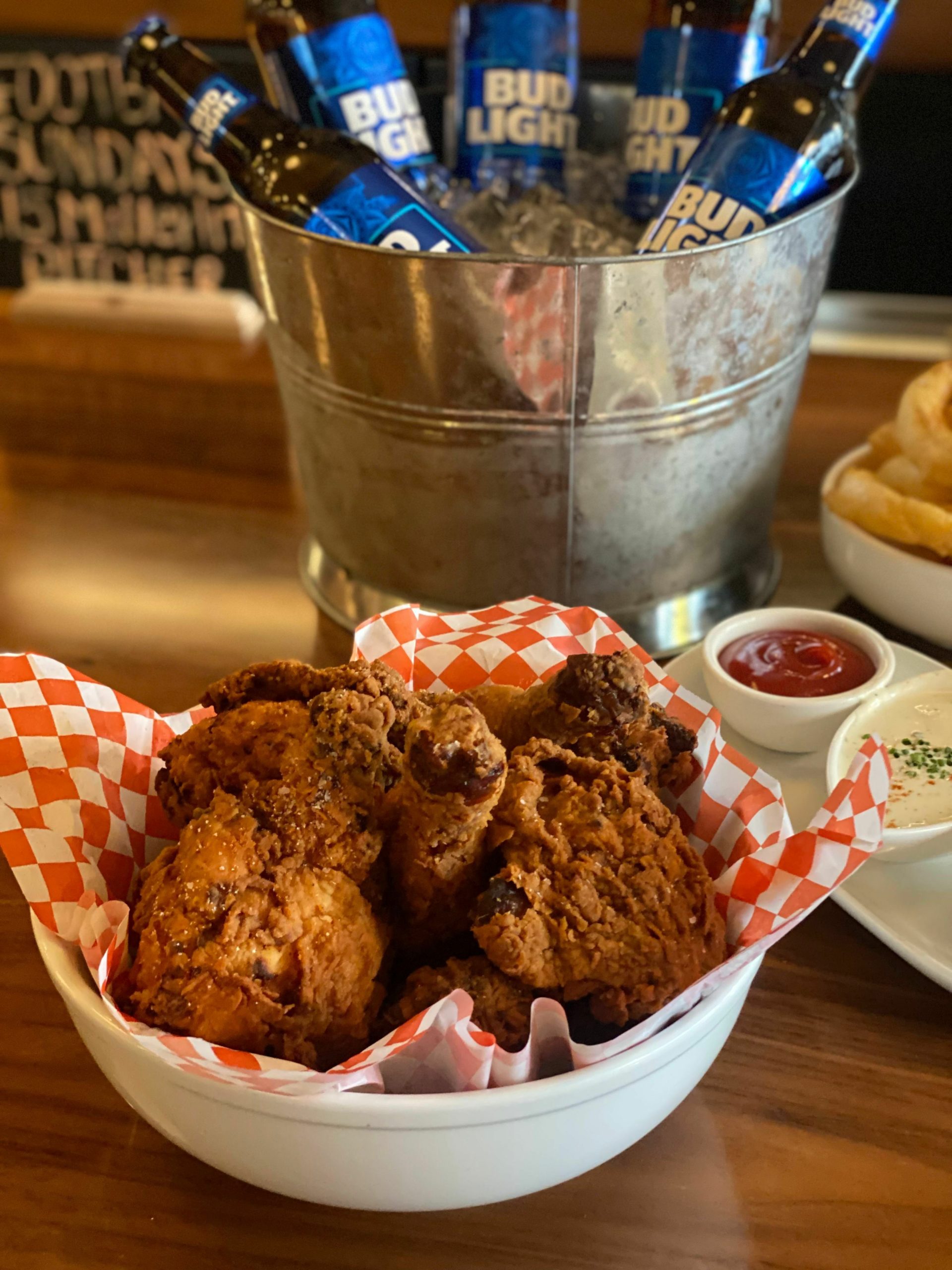 Main Street Tavern's buttermilk fried chicken with onion rings and beer.