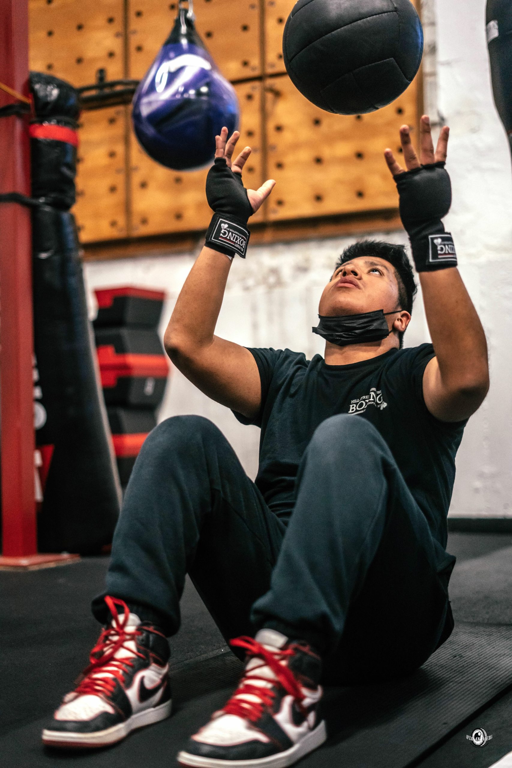 Hampton Bays student Roger Urizar tosses a medicine ball during a workout. DYLAN FLORES