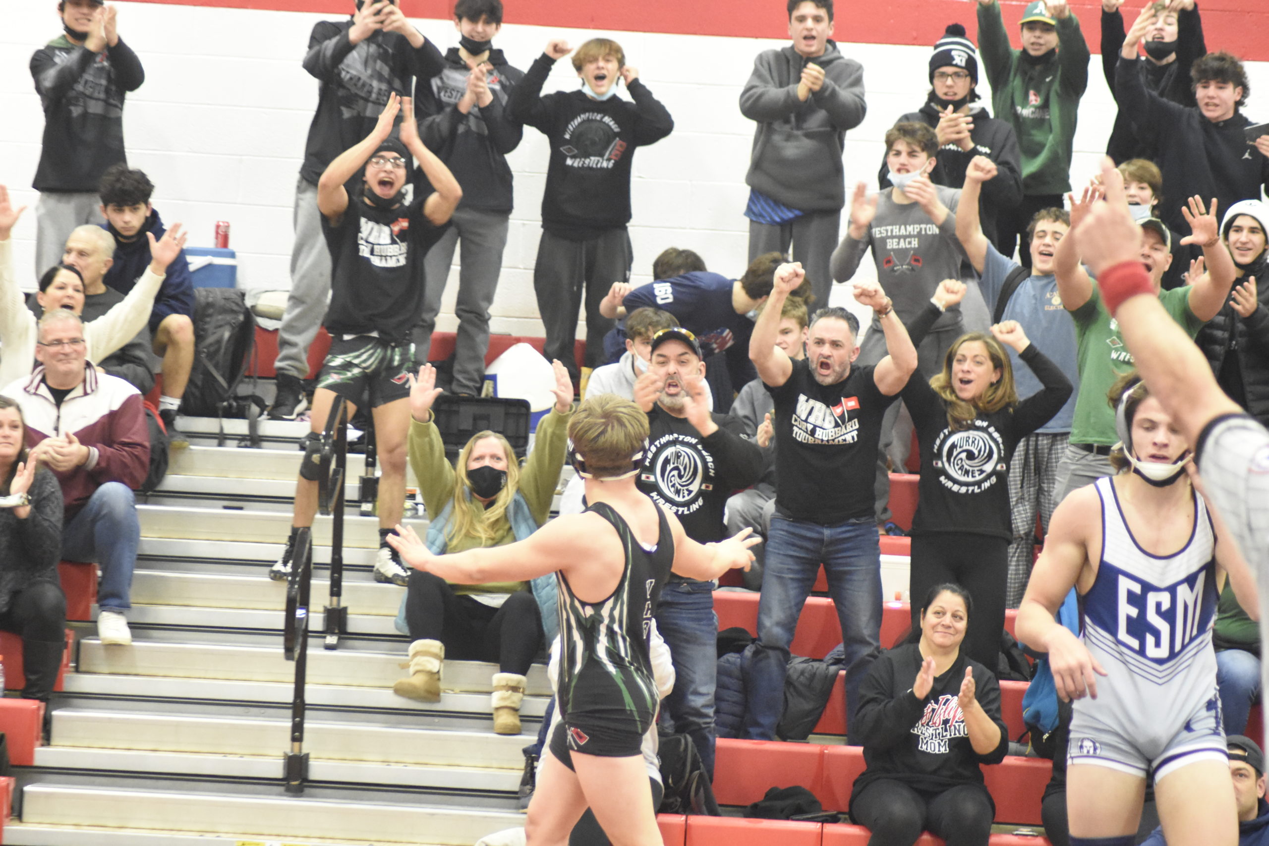 The Westhampton Beach crowd is pumped up after Dom Jurgel won the league title at 172 pounds.