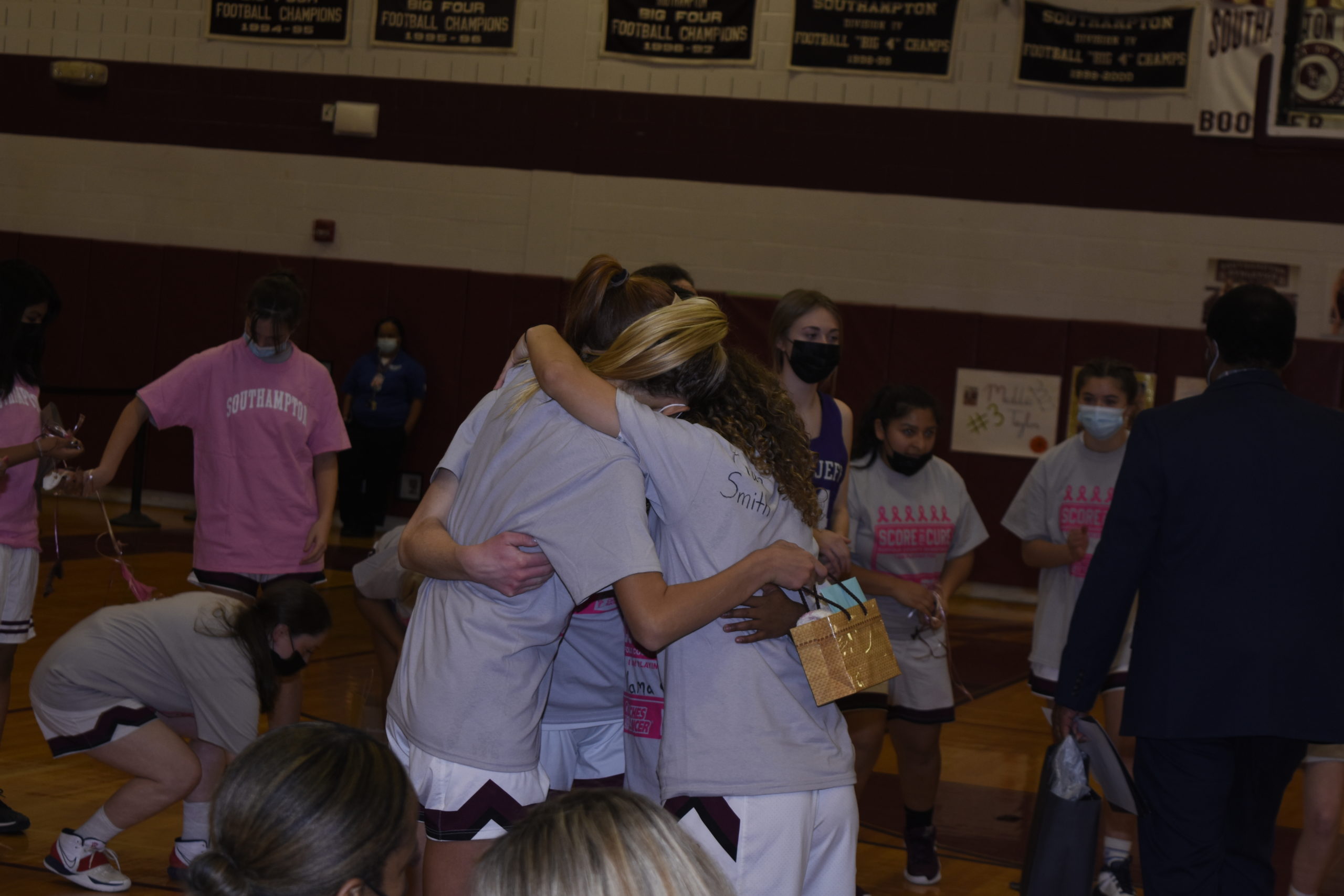 The four seniors, Carli Cameron, Hallie Beeker, Madison Taylor and Gabriella Arnold, embrace one another after the team honors them.