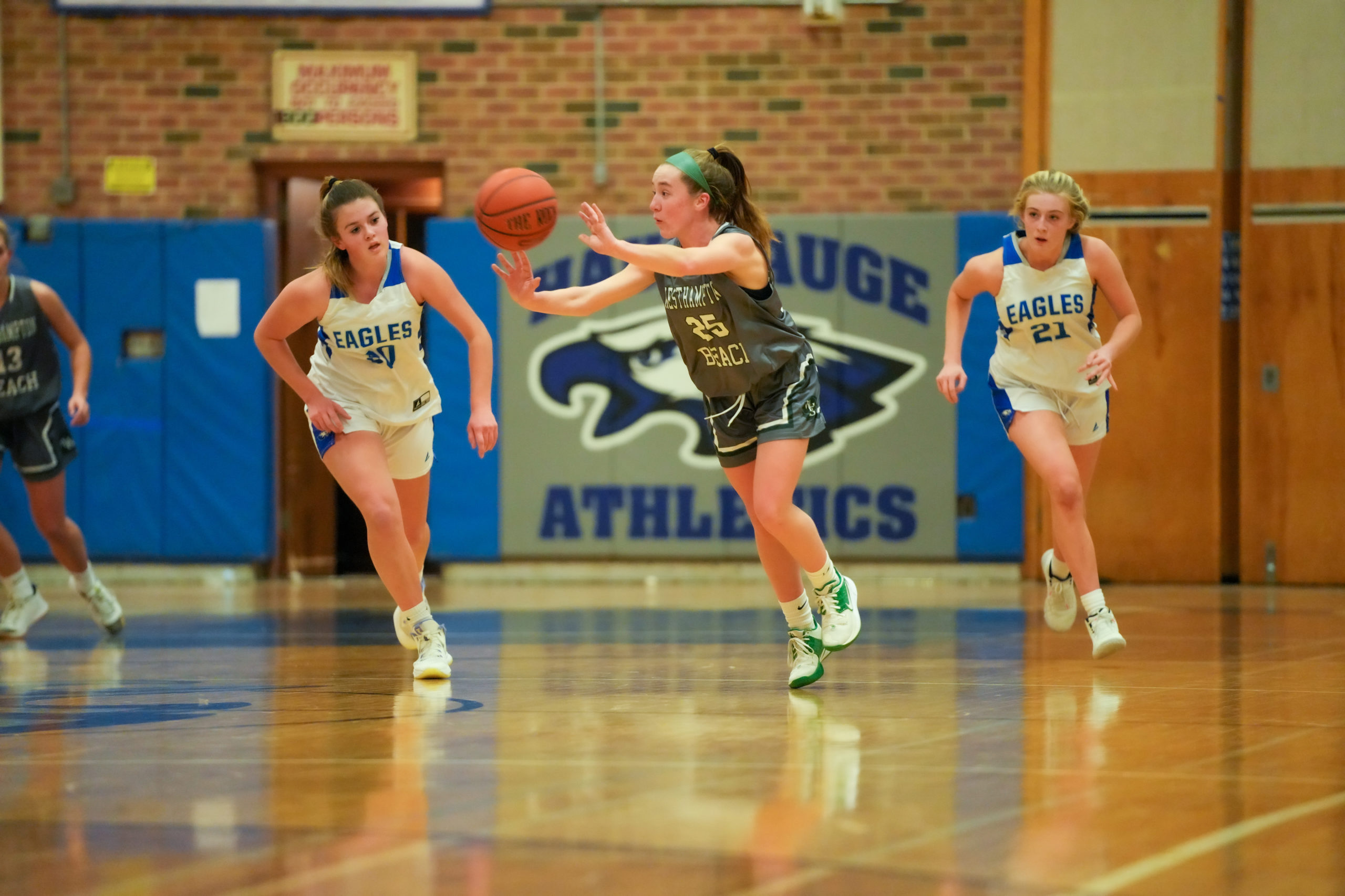 Lily Berchin passes the ball as she makes her way through the middle of the court. RON ESPOSITO
