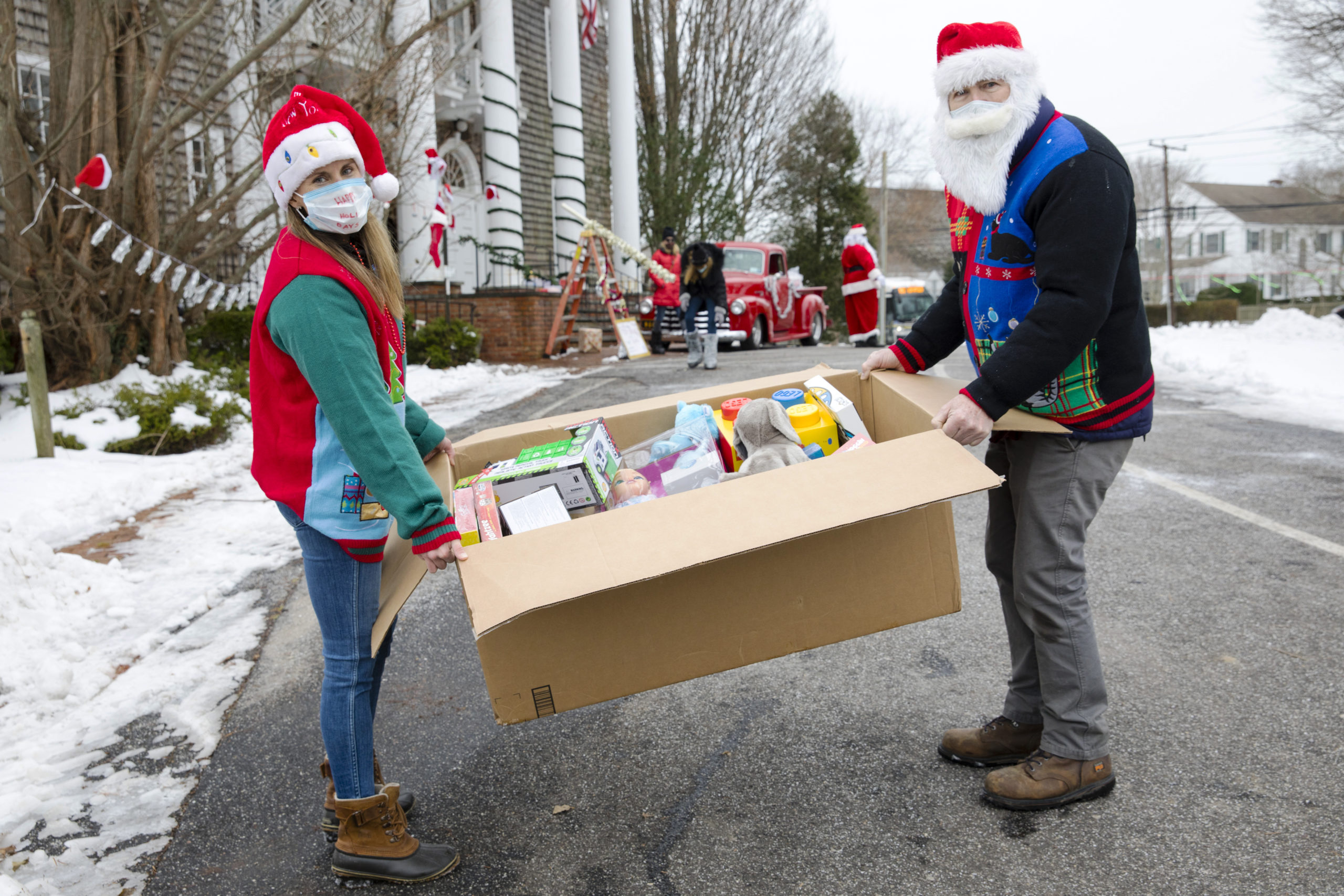 Hampton’s Community Outreach Organizaion holds a toy drive at the Bridgehampton Community Center on Sunday, December 21, 2020. Marit Molin, founder, and Chuck MacWhinnie, volunteer, unload a box of donations.