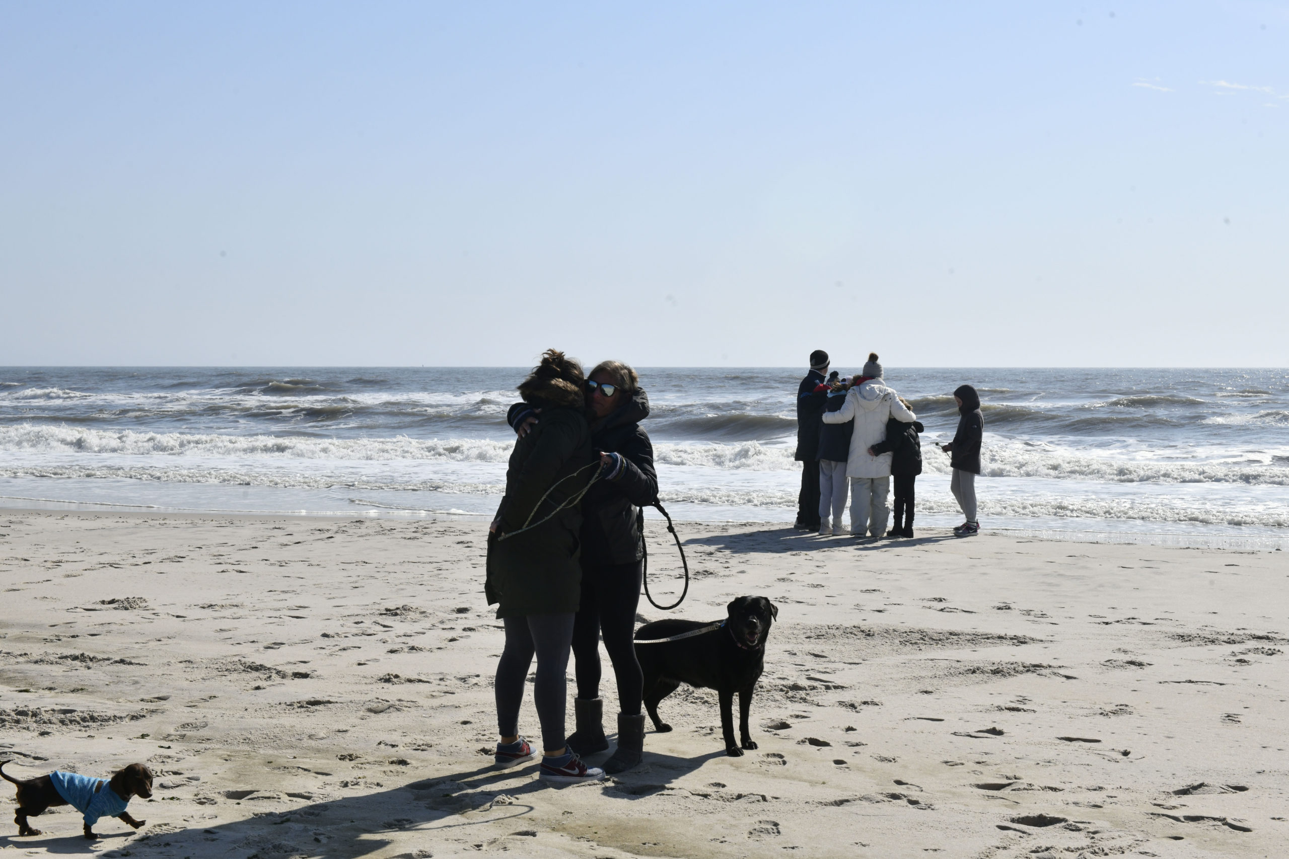 Fellow lifeguards and friends gathered at Ponquogue Beach on Saturday to the mourn the loss of Ciara McKeon.  DANA SHAW