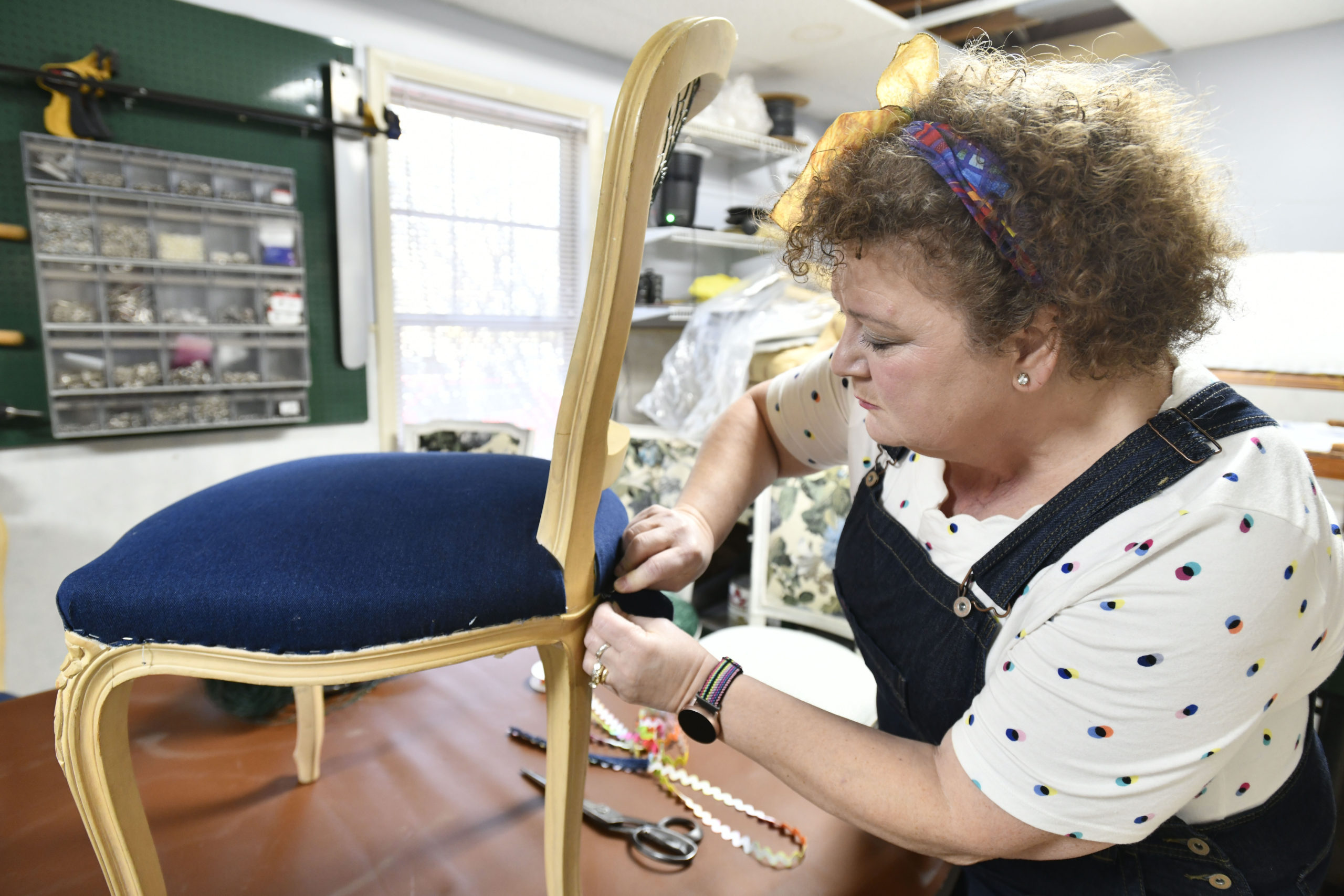 Susan Sinclair works on a custom chair in her Hampton Bays workshop.  DANA SHAW