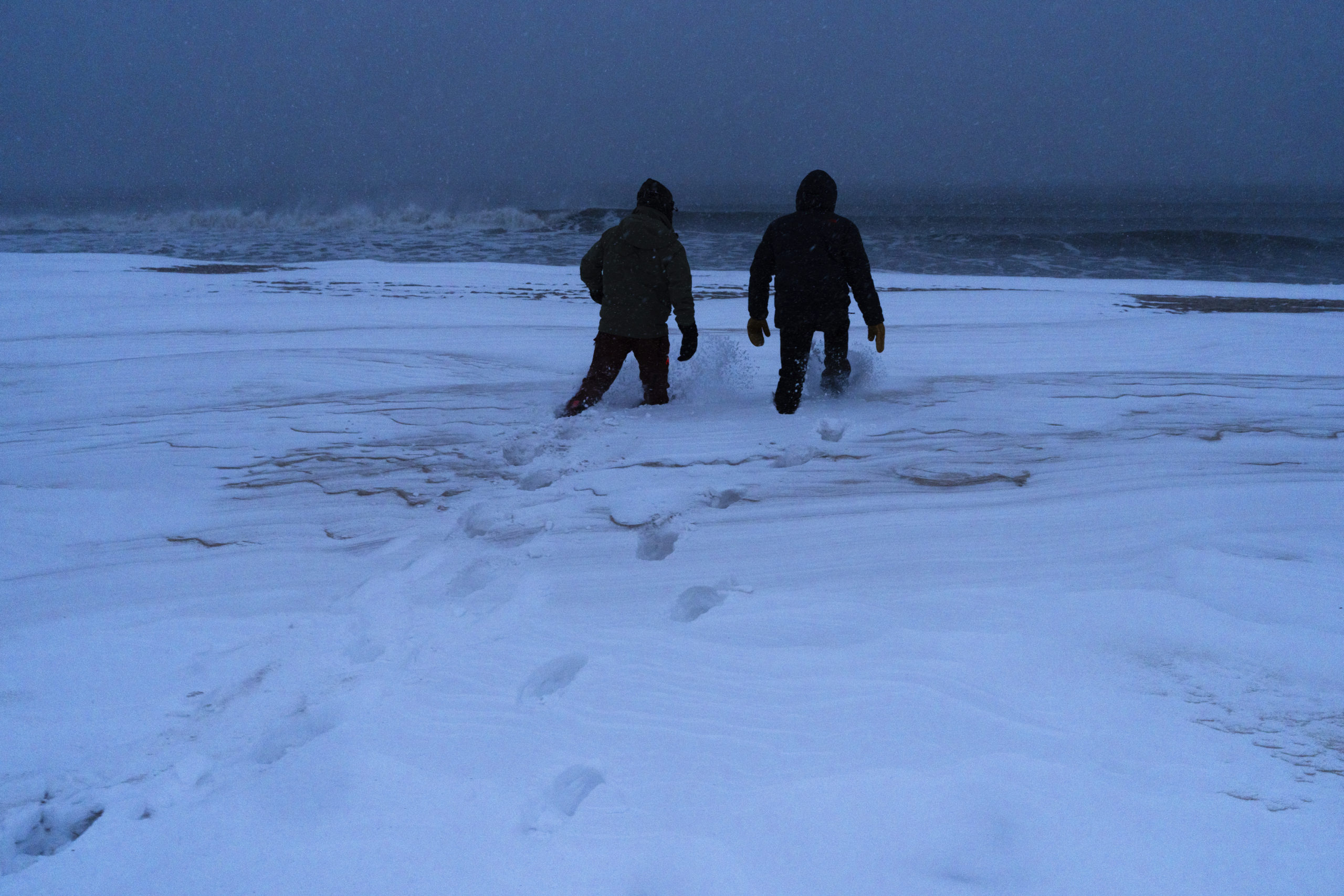 Surfers Nico and Brian Pollak check out the waves during the Blizzard of '22 on Saturday in Bridgehampton.  LORI HAWKINS
