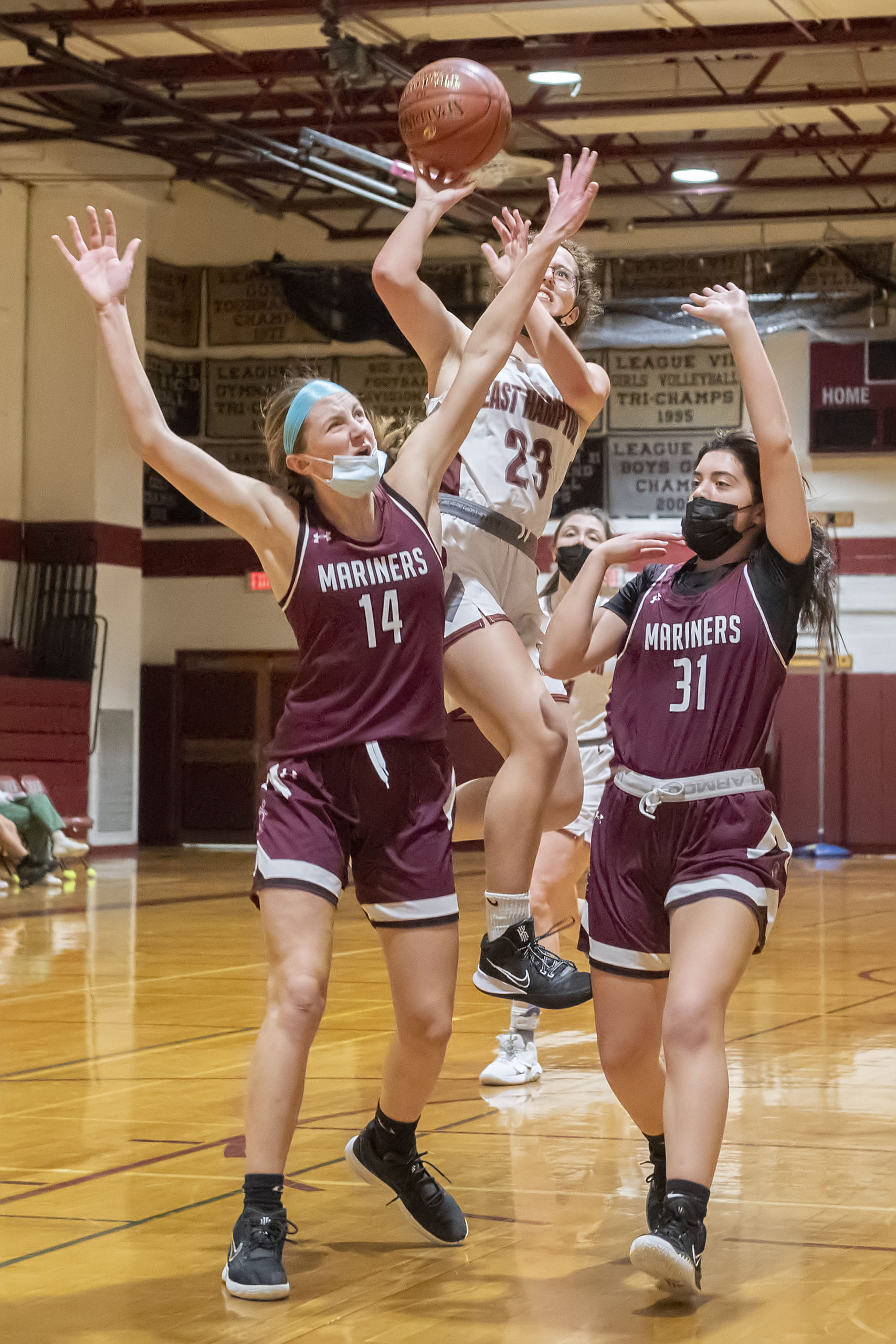 East Hampton's Chloe Swickard works to shoot between a tough defense of Juliette Archer and Celia Ginsberg.