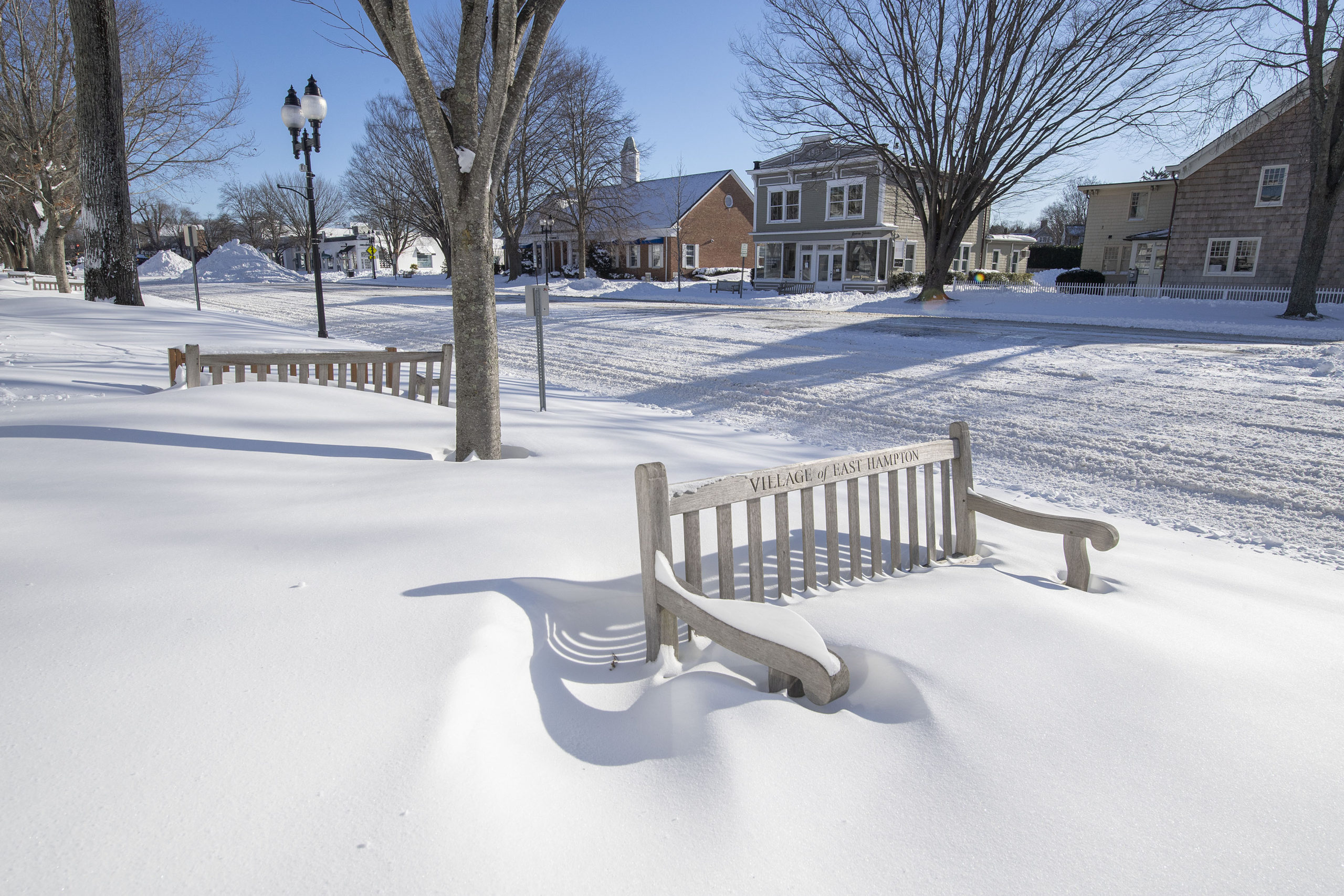 Benches along East Hampton's Main Street following the January Blizzard of '22 on Sunday morning.  MICHAEL HELLER