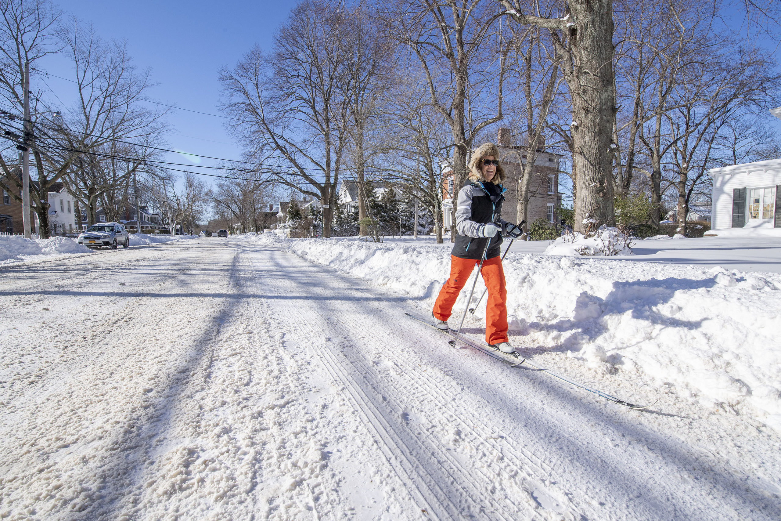 Laura Grenning skis down Main Street in Sag Harbor following the January Blizzard of '22 on Sunday morning.   MICHAEL HELLER