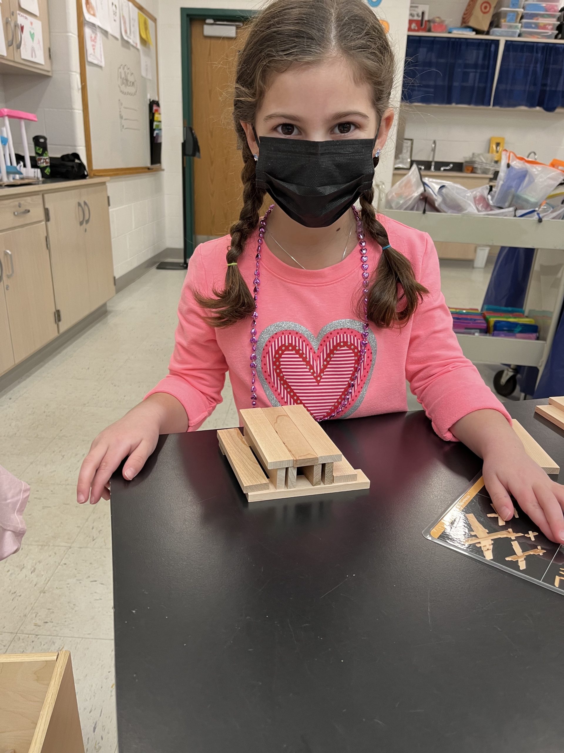 East Quogue Elementary School students have been inventing and engineering with their teacher,  Kelly Hogan,  in the STEAM Lab. Giada Paga shows off the picnic bench she built using Keva planks.