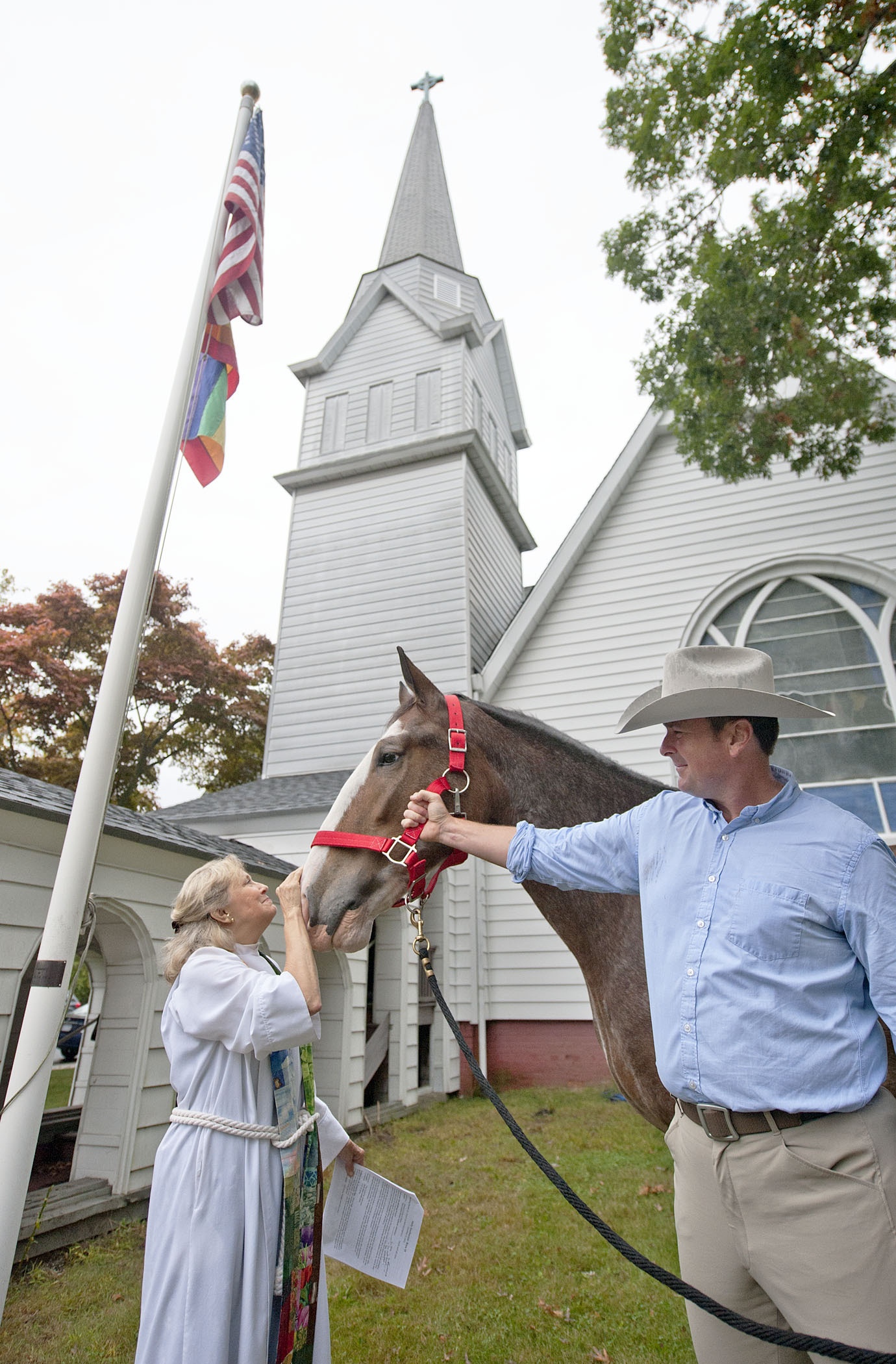 Reverend Karen Campbell with a horse at a recent Blessing of the Animals at Christ Episcopal Church. MICHAEL HELLER