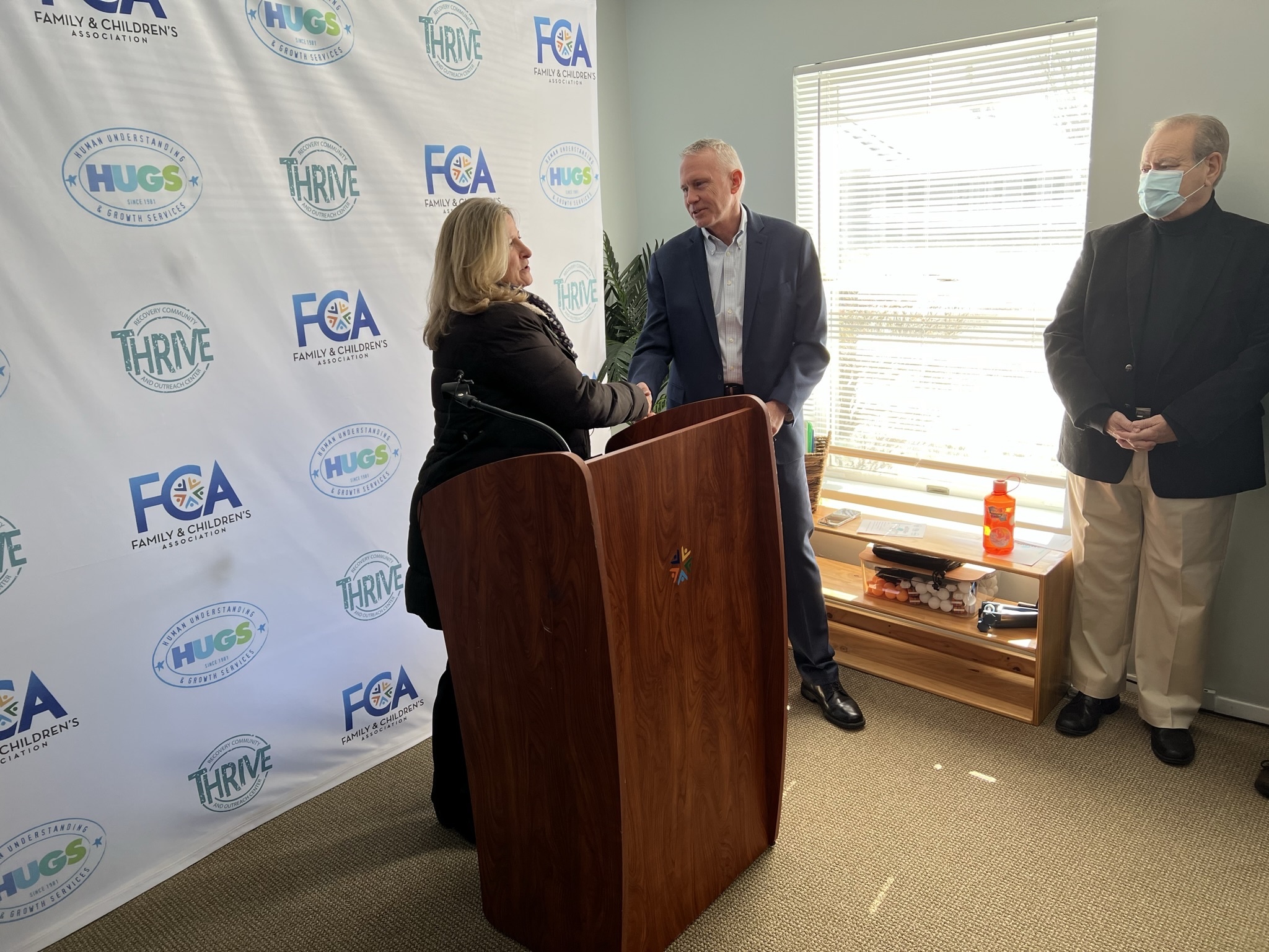 Westhampton Beach Mayor Maria Moore congratulates Family and Children's Associates CEO Jeff Reynolds during a ceremony at the opening of the Thrive recovery center in Westhampton Beach on Monday. BILL SUTTON