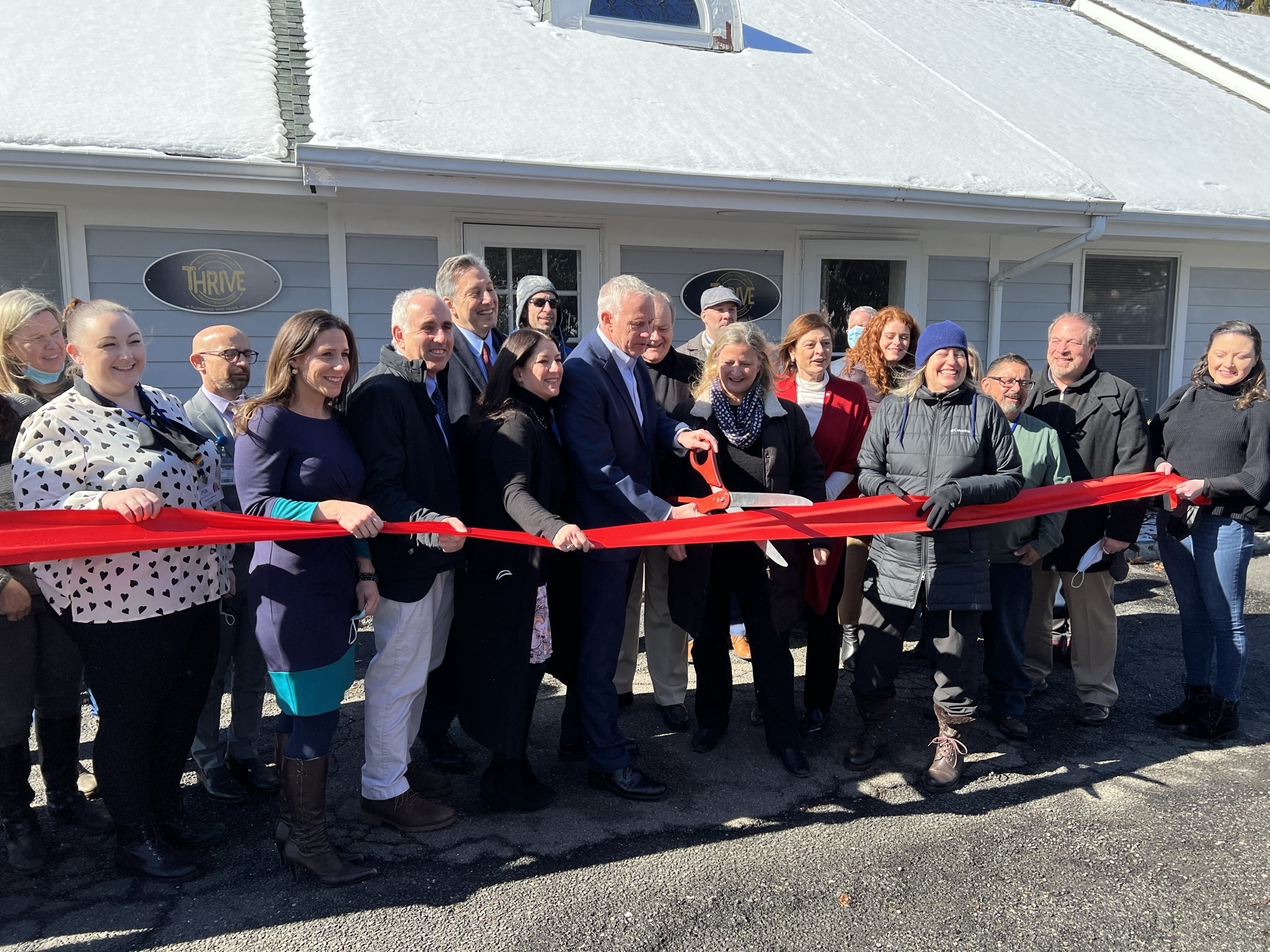 Officials cut a ceremonial ribbon at the opening of speaks during a ceremony at the opening of the Thrive recovery center in Westhampton Beach on Monday. BILL SUTTON