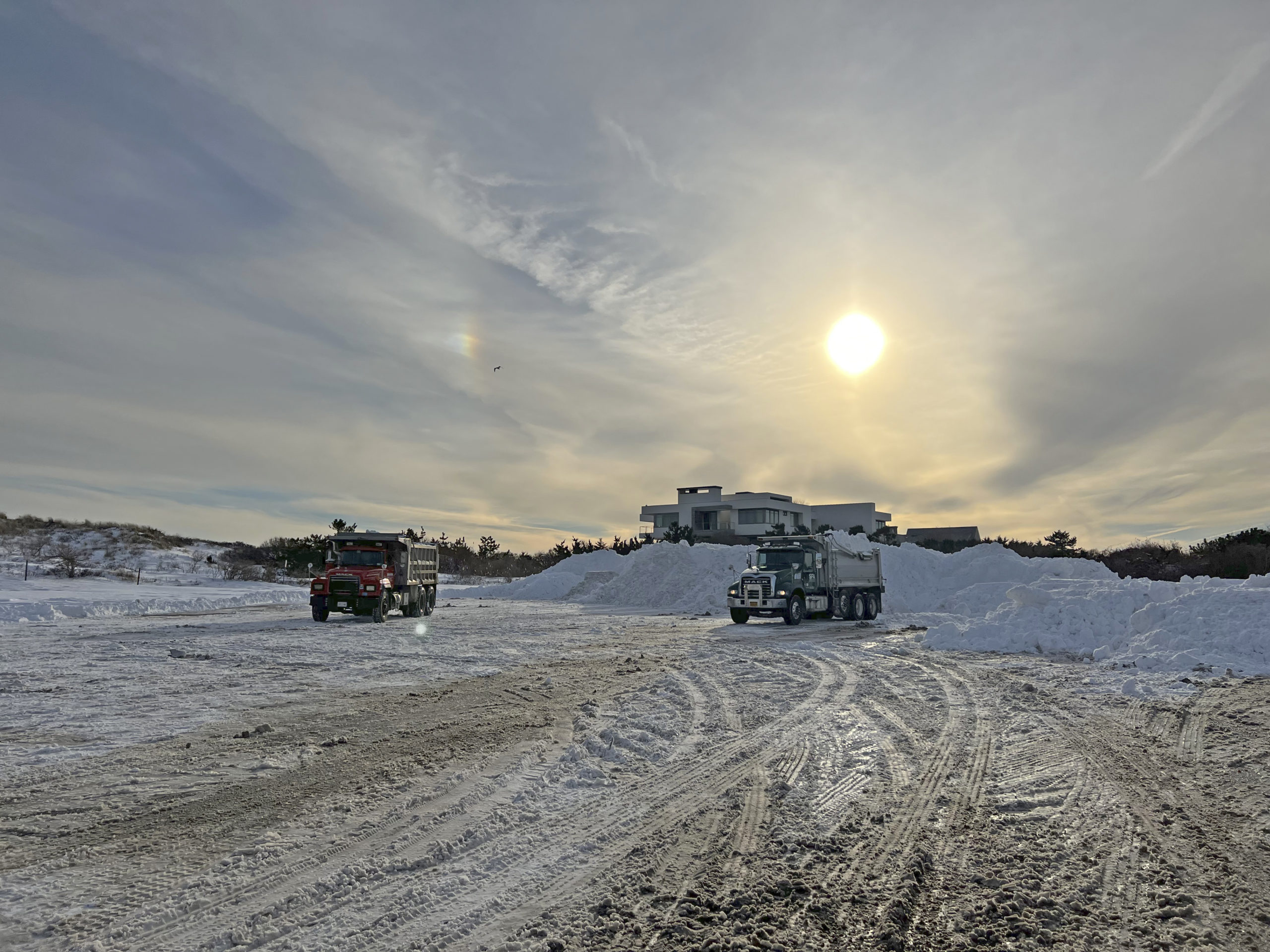 Trucks dump loads of snow at Coopers Beach on February 7.  DANA SHAW