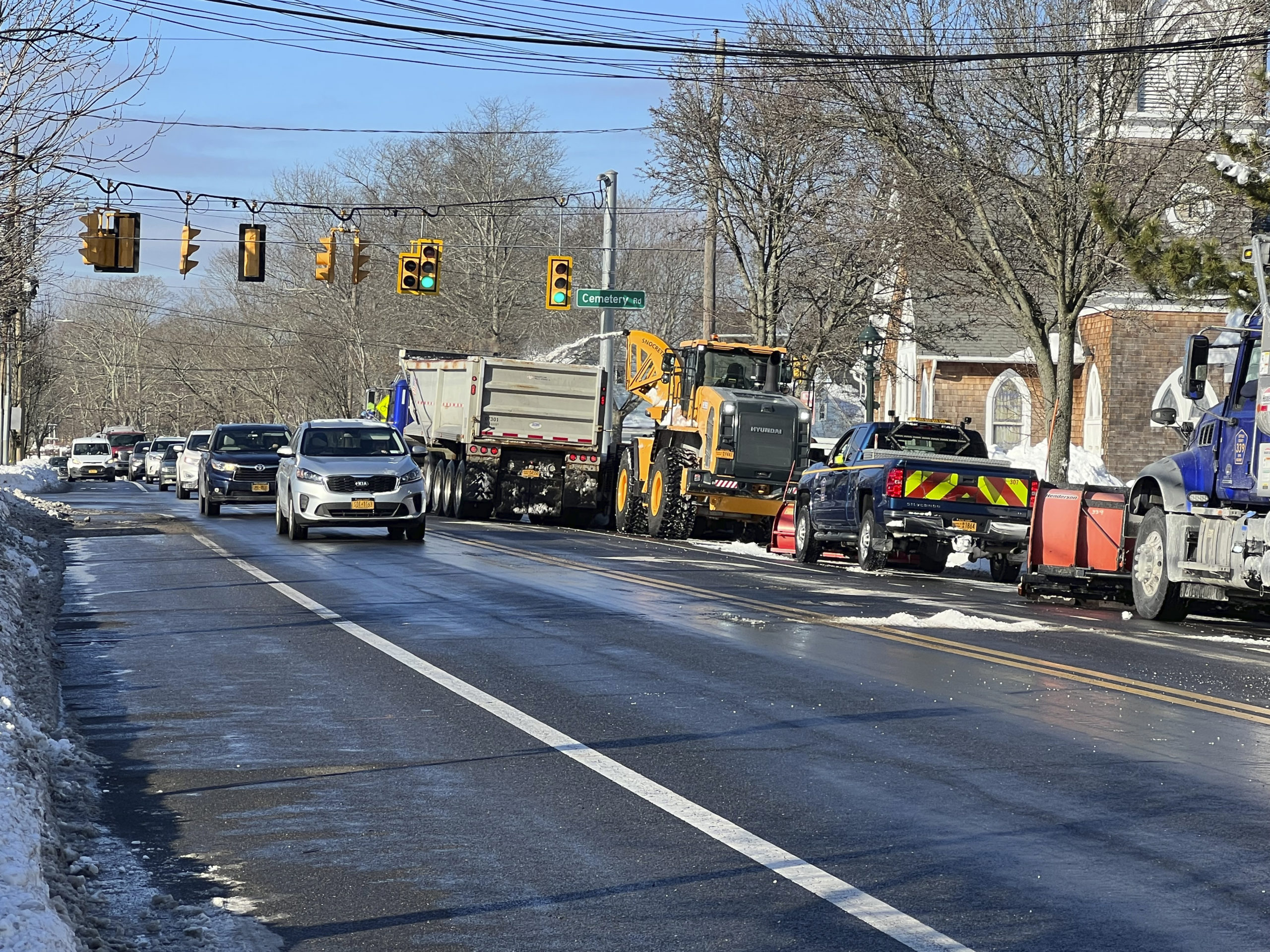 Snow was still being cleared on Montauk Highway in Hampton Bays on Tuesday morning. Municipalities, businesses and residents are still digging out after a massive storm blew through the area over the weekend.  DANA SHAW