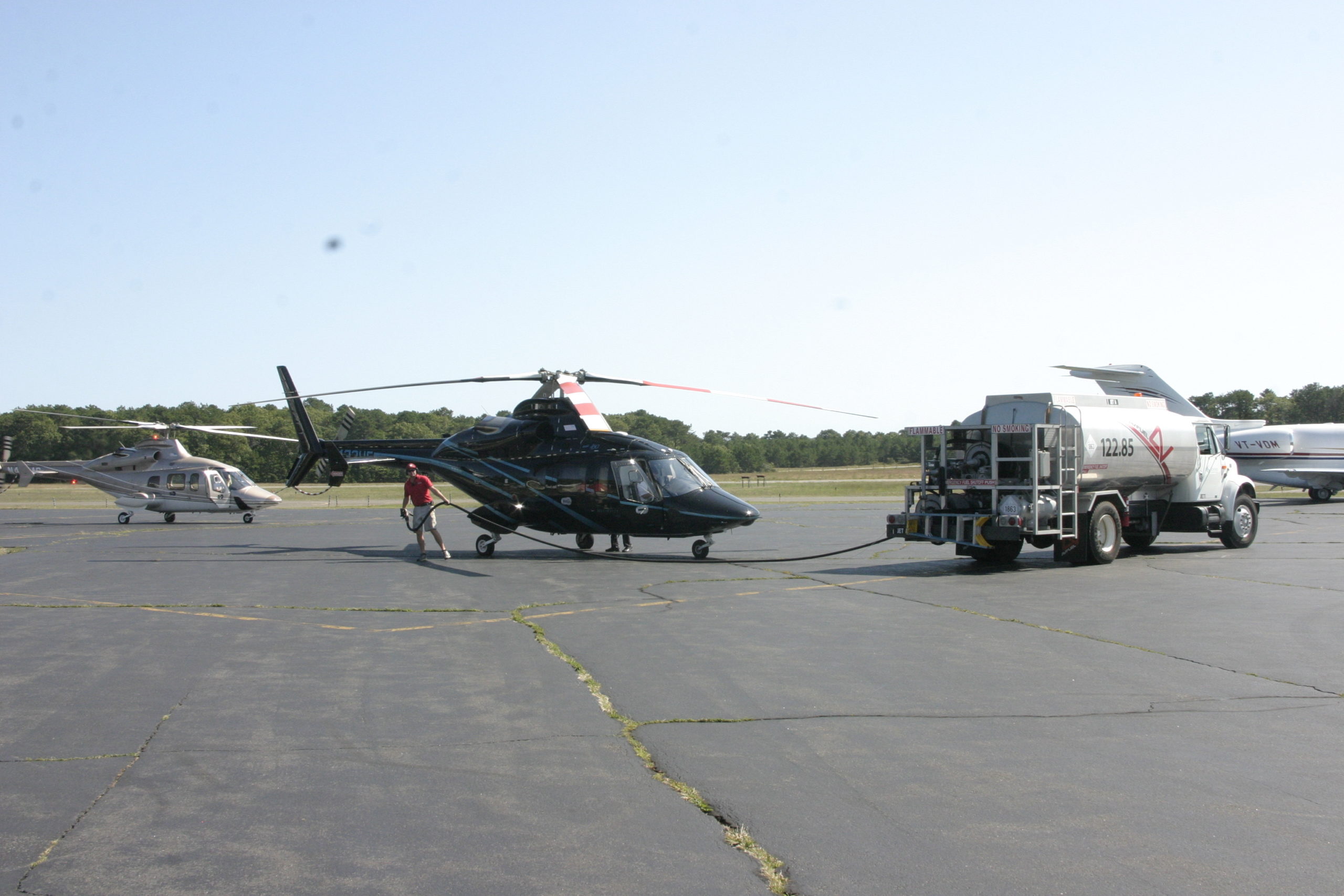 Commuter helicopters refueling at East Hampton Airport during a busy summer season.