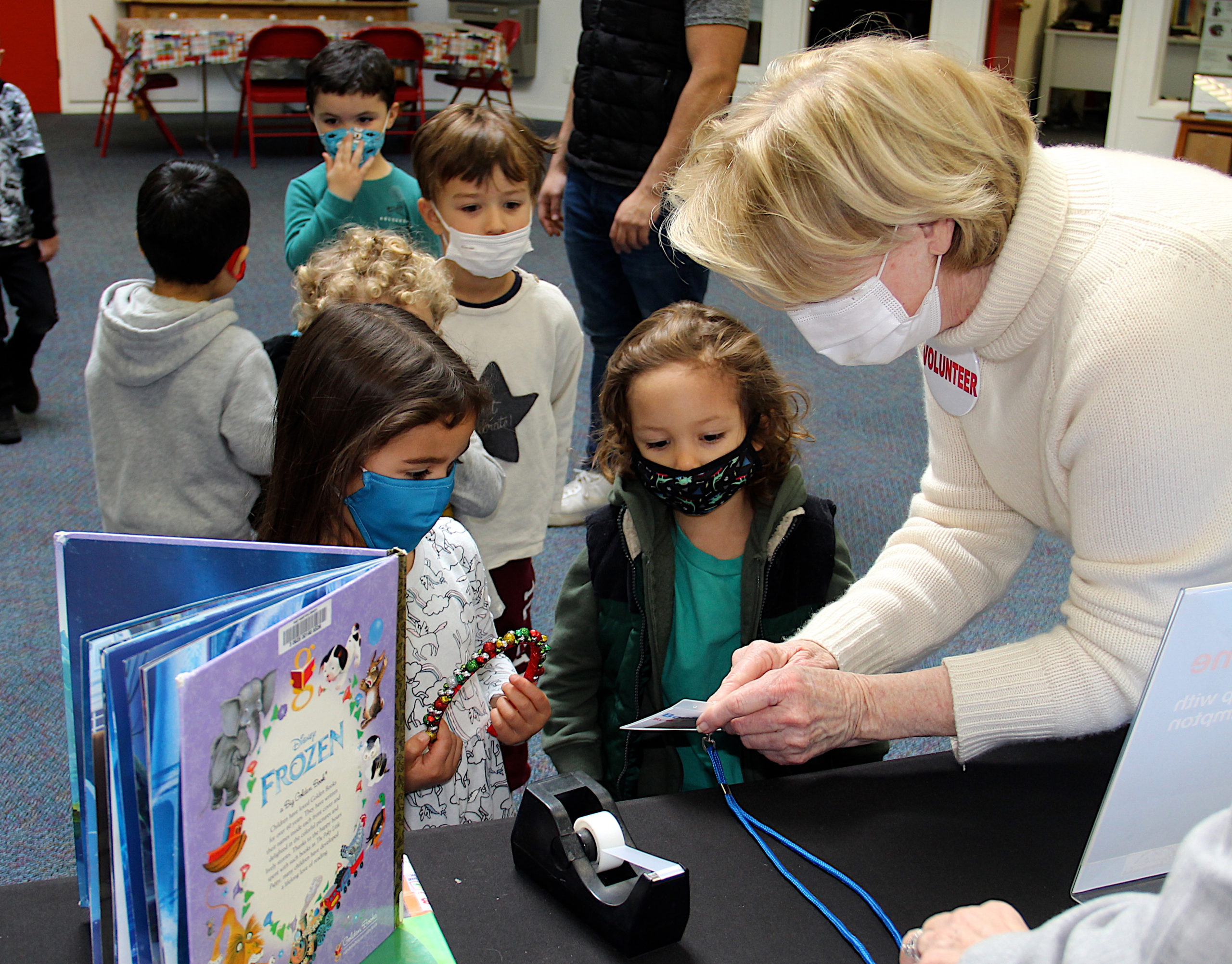 Amara Maldonado, Austin Brito and volunteer Tess Wachs at Book Time.  KYRIL BROMLEY