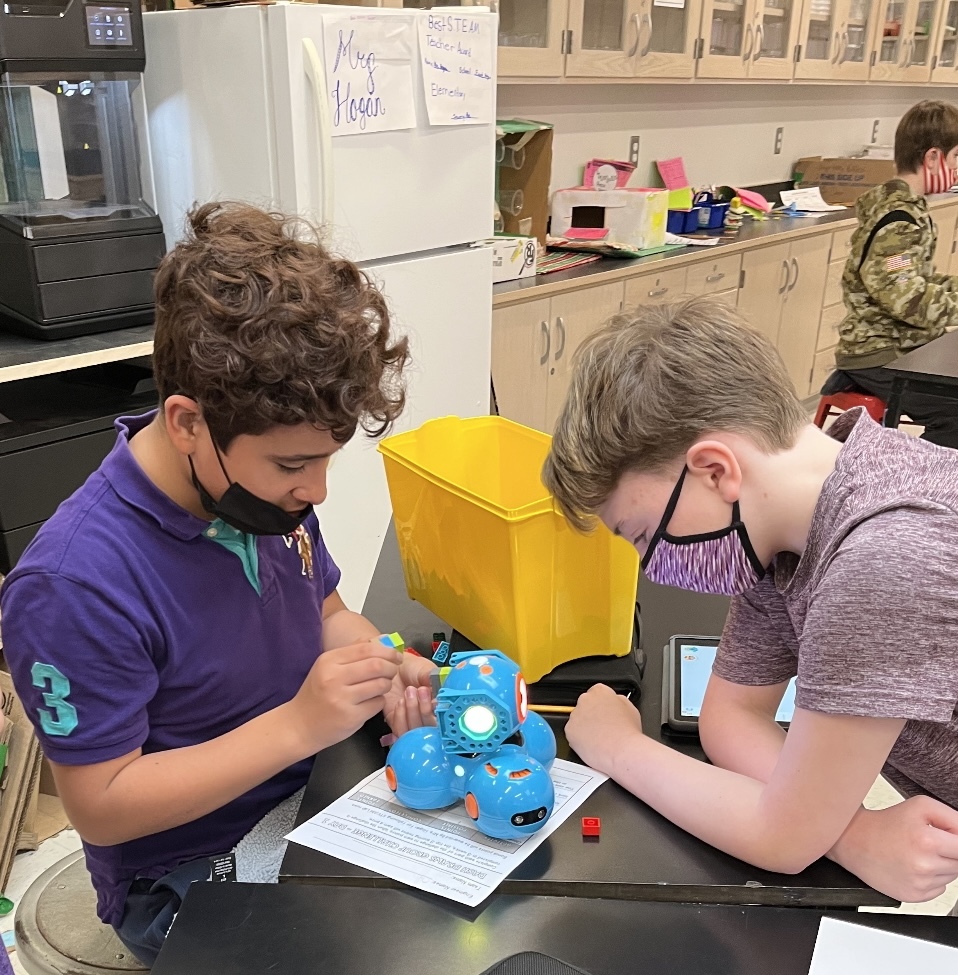East Quogue Elementary School students have been inventing and engineering with their teacher,  Kelly Hogan,  in the STEAM Lab. Christopher Garcia Barrientos and Daniel Schaeffer use Legos to engineer a marker holder for the Dash robot to program Dash to draw.