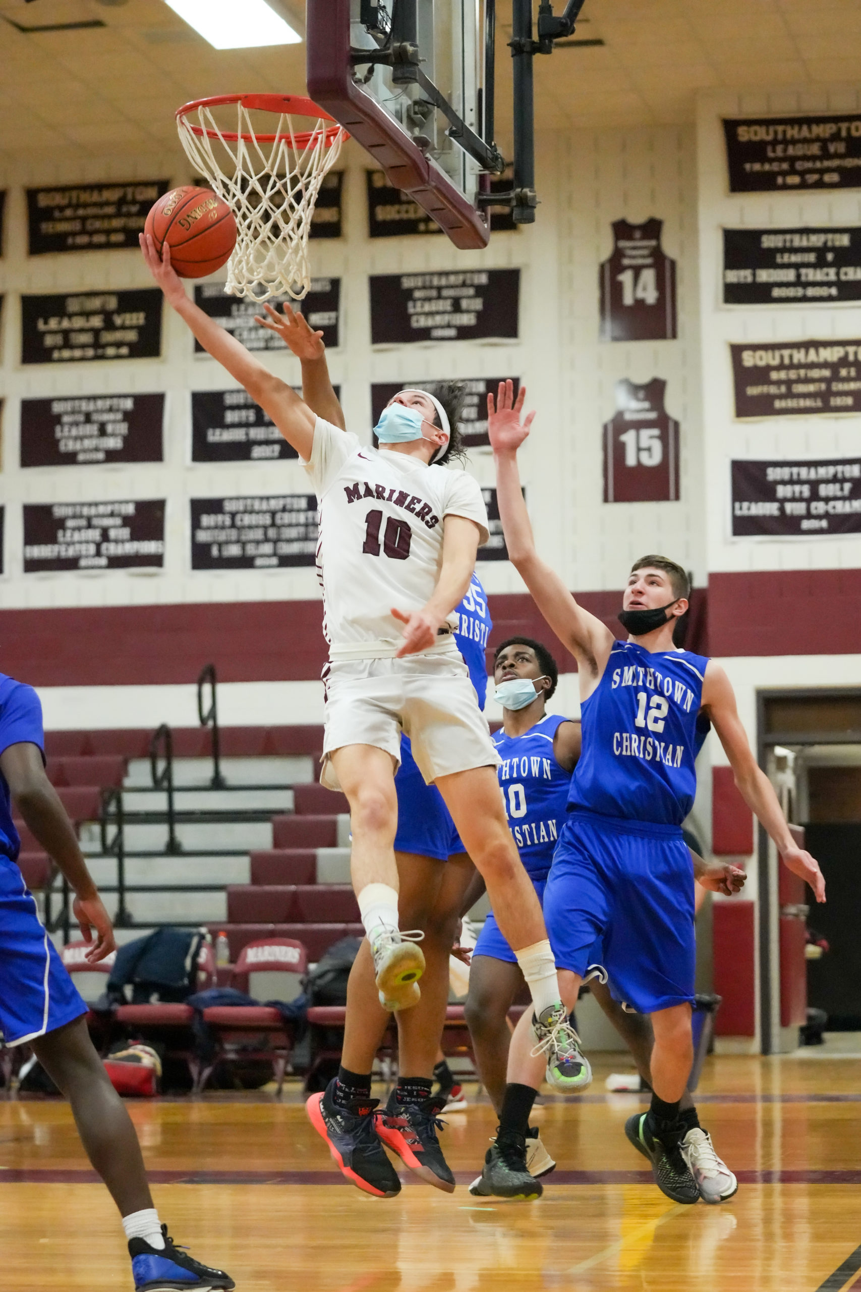 Senior Mariner Andrew Venesina hits a reverse layup.