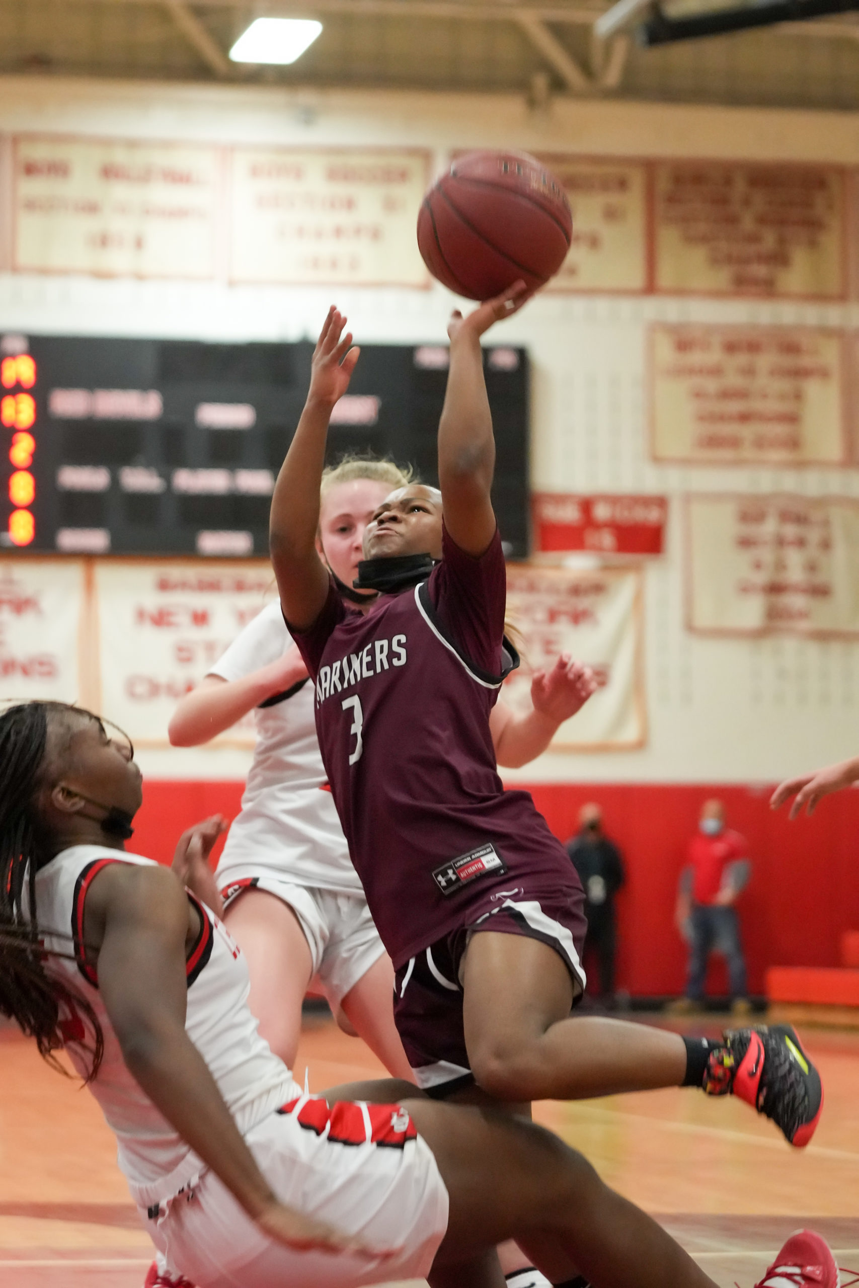 Maddie Taylor absorbs some contact from Climele Browne of Center Moriches.