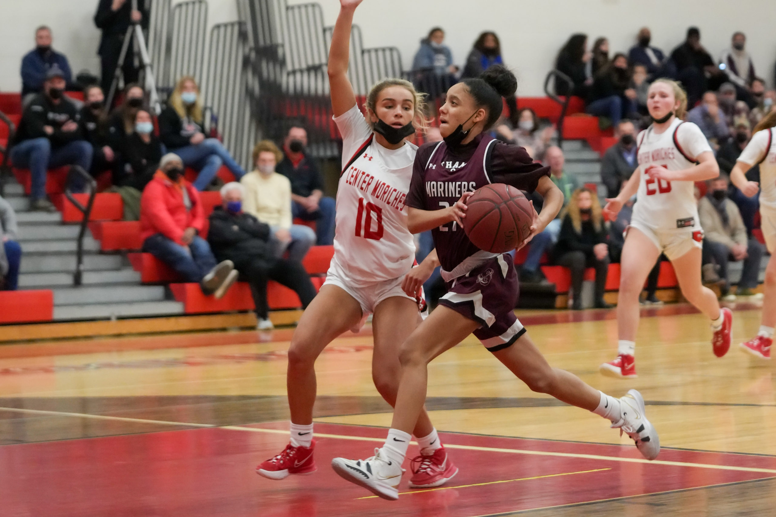 Southampton freshman Daelyn Palmore drives on Charlotte Castiglione of Center Moriches.