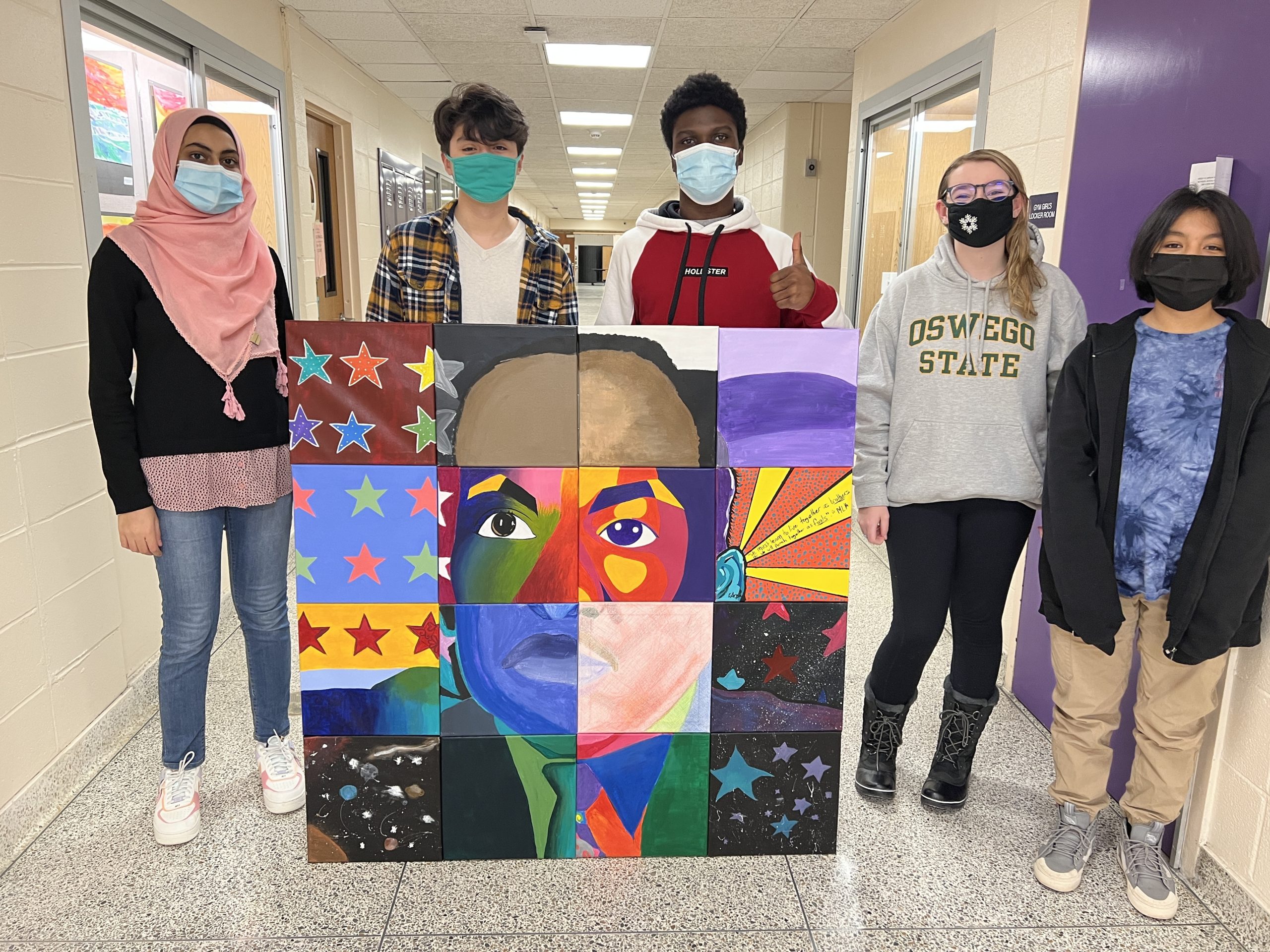 From left, Hampton Bays students Minal Naeem, Kevin Guzman, Eli Amos, Emily Barns, and Melina Rojas with their completed Martin Luther King Jr. portrait, which they worked on, with several other Hampton Bays students.