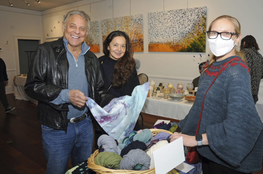 Stephen Meringoff and Kiki Rollemberg with Ashley Edmund at the Ashawagh Hall Spring Craft Fair on Saturday.     RICHARD LEWIN