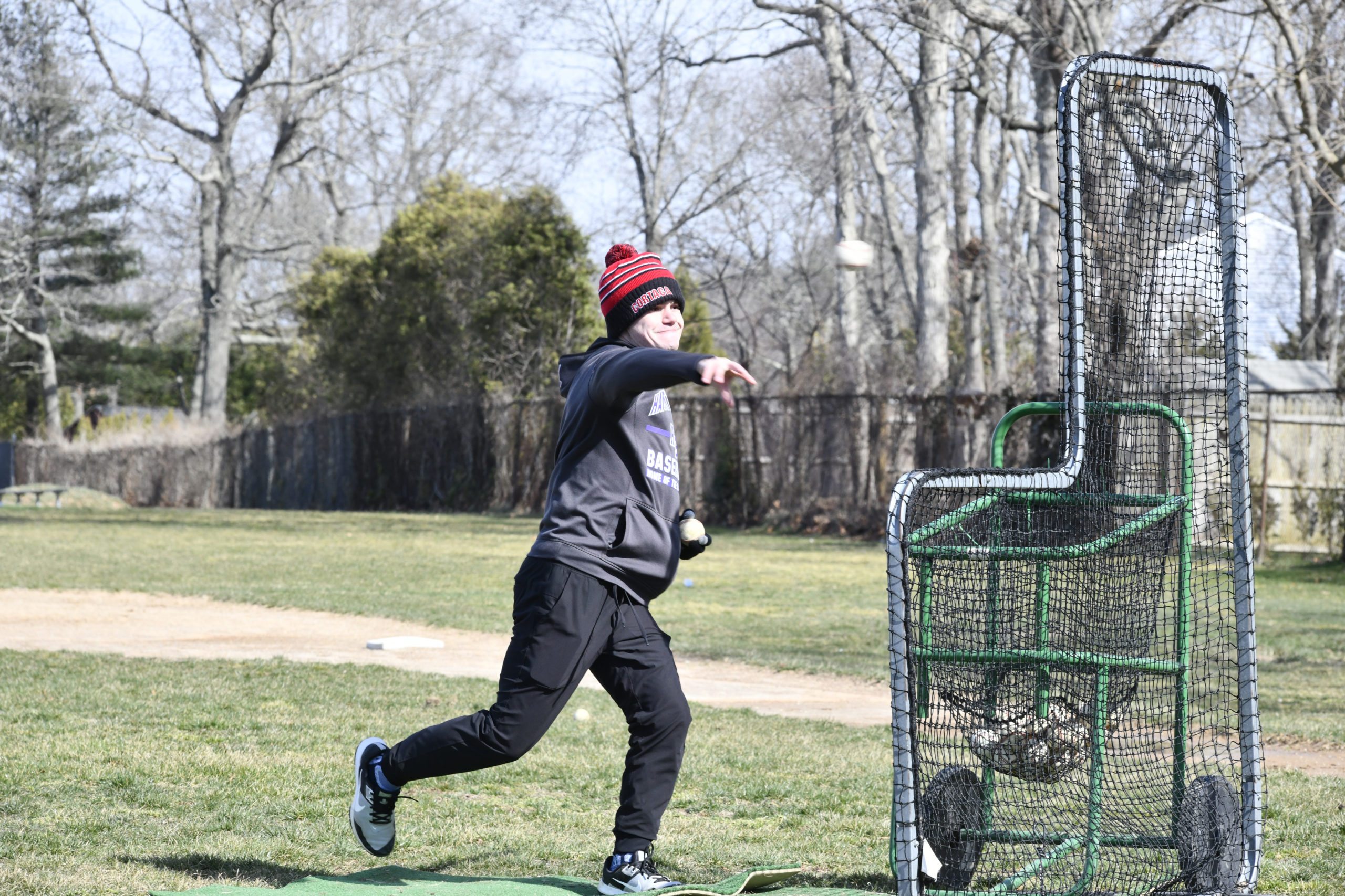 Assistant coach Andrew Hafemeister throws some batting practice on Monday.  DANA SHAW