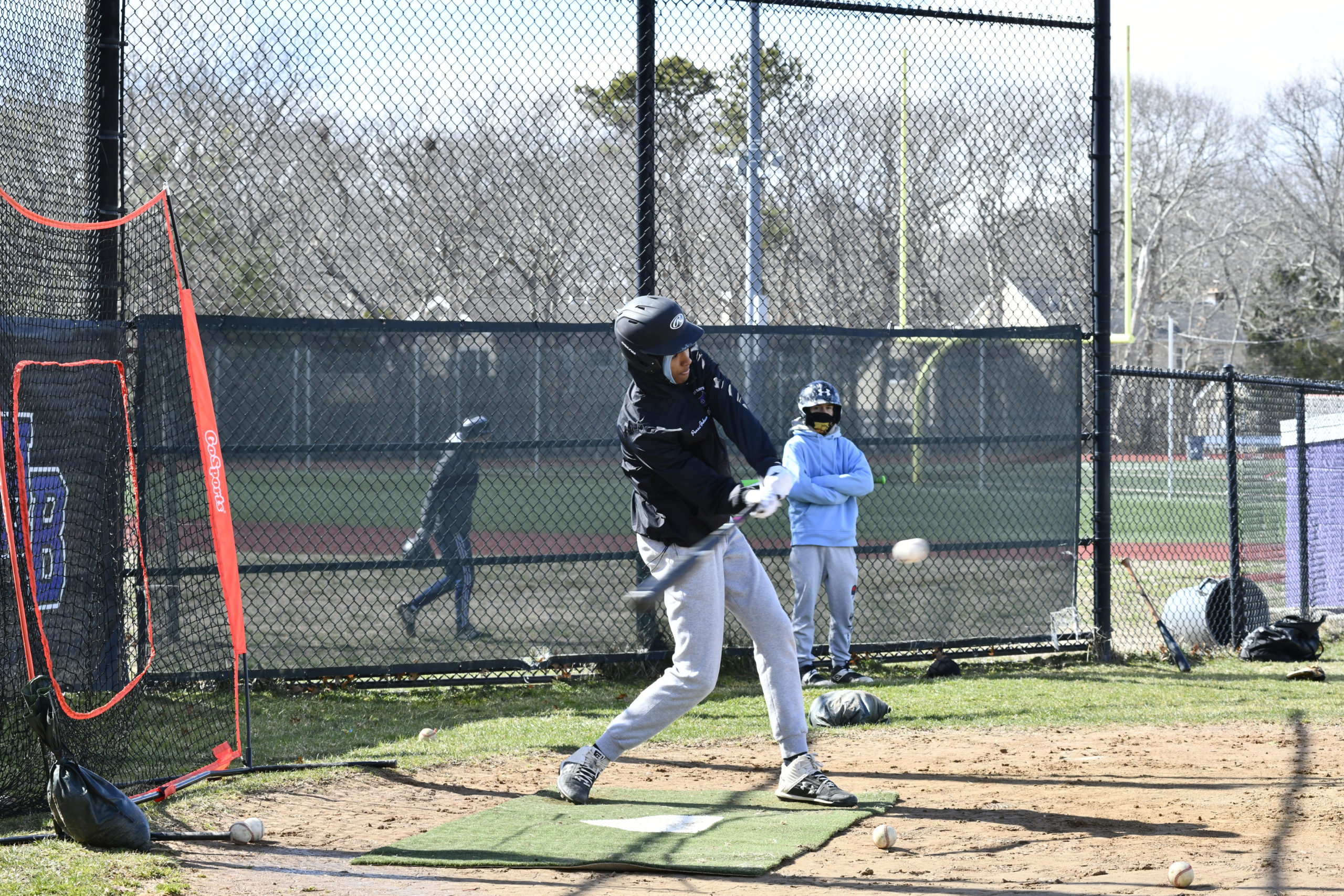 A Hampton Bays player takes a cut during frigid temperatures at Monday's practice.  DANA SHAW