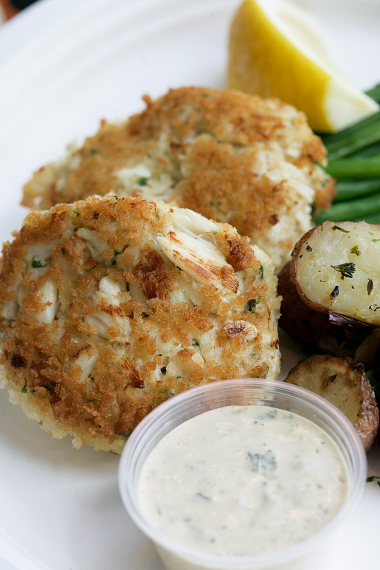 Crab cakes at Bostwick's. The East Hampton restaurant reopens on March 31. ERIC STRIFFLER