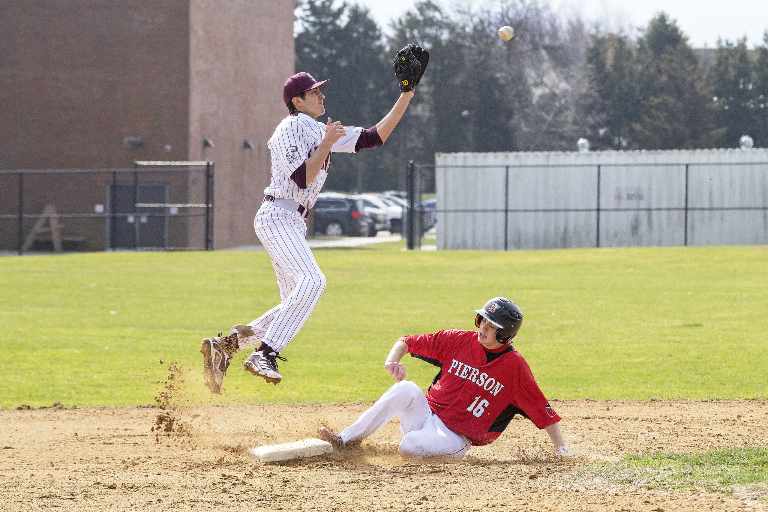 Southampton's Zack Valk leaps to try and catch a high throw coming in to second base.   MICHAEL HELLER